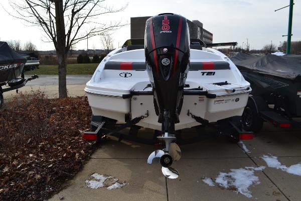 2025 Tahoe T21 boat with powerful outboard motor, parked on a concrete surface.