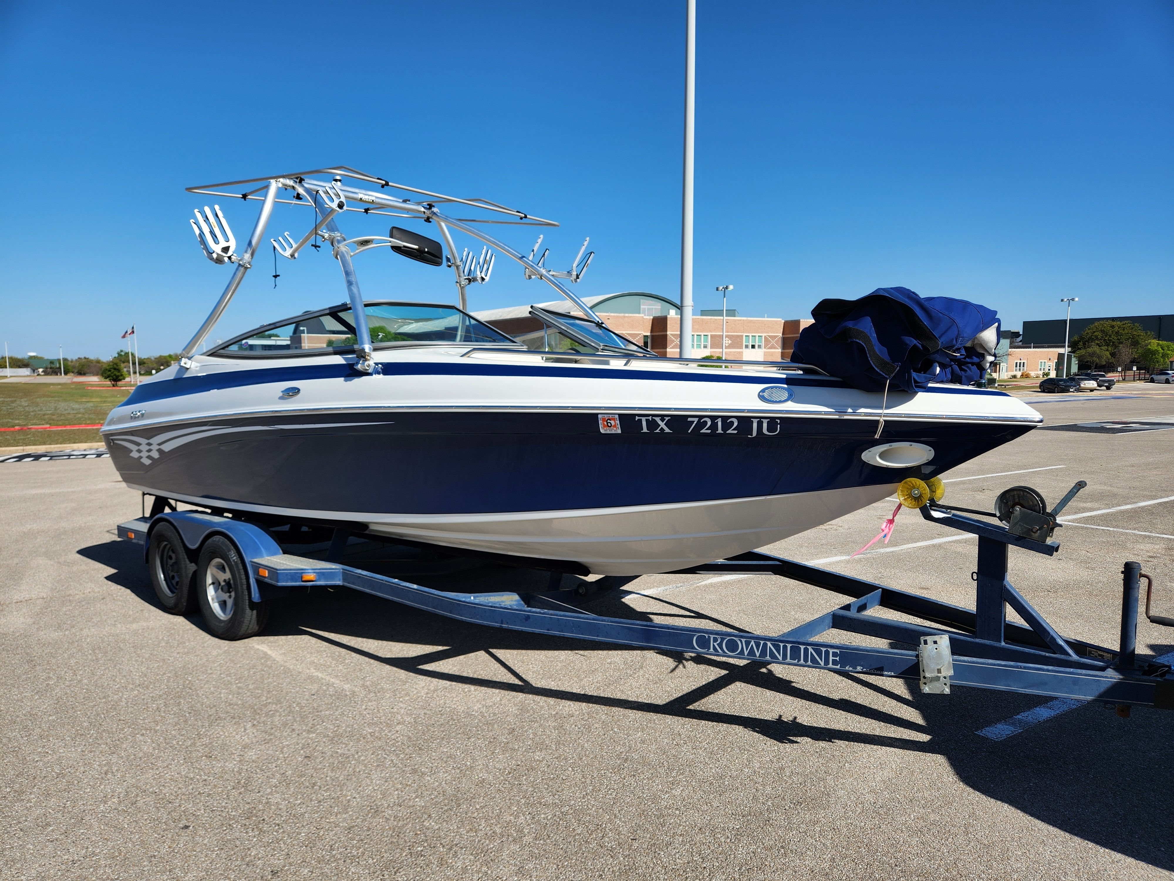 2003 Crownline 225 BR boat parked on trailer outdoors.