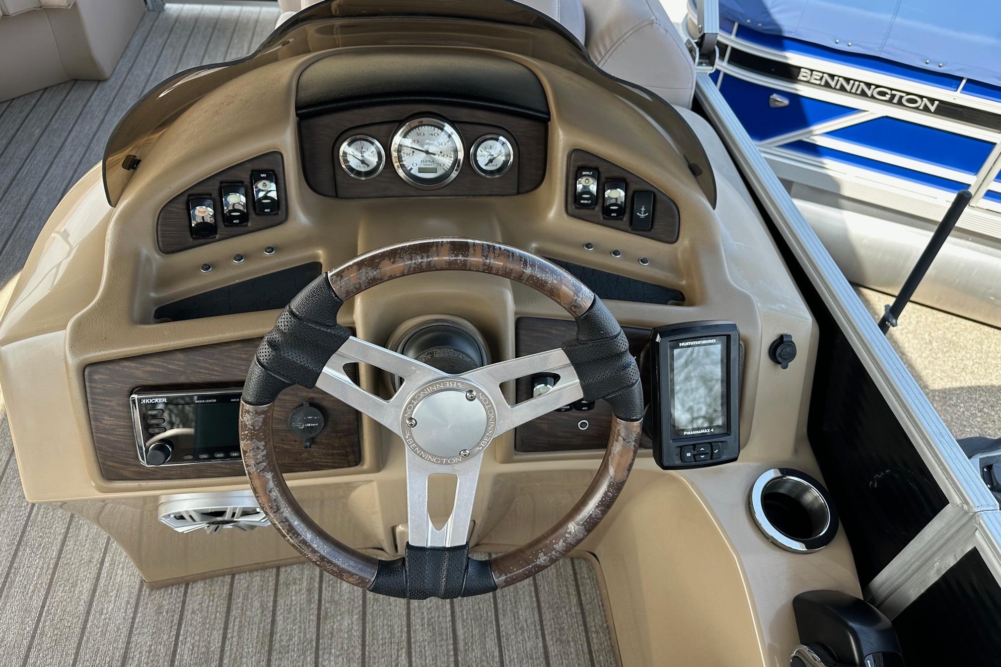 Steering console of a 2017 Bennington 22 GPD boat with gauges and controls.