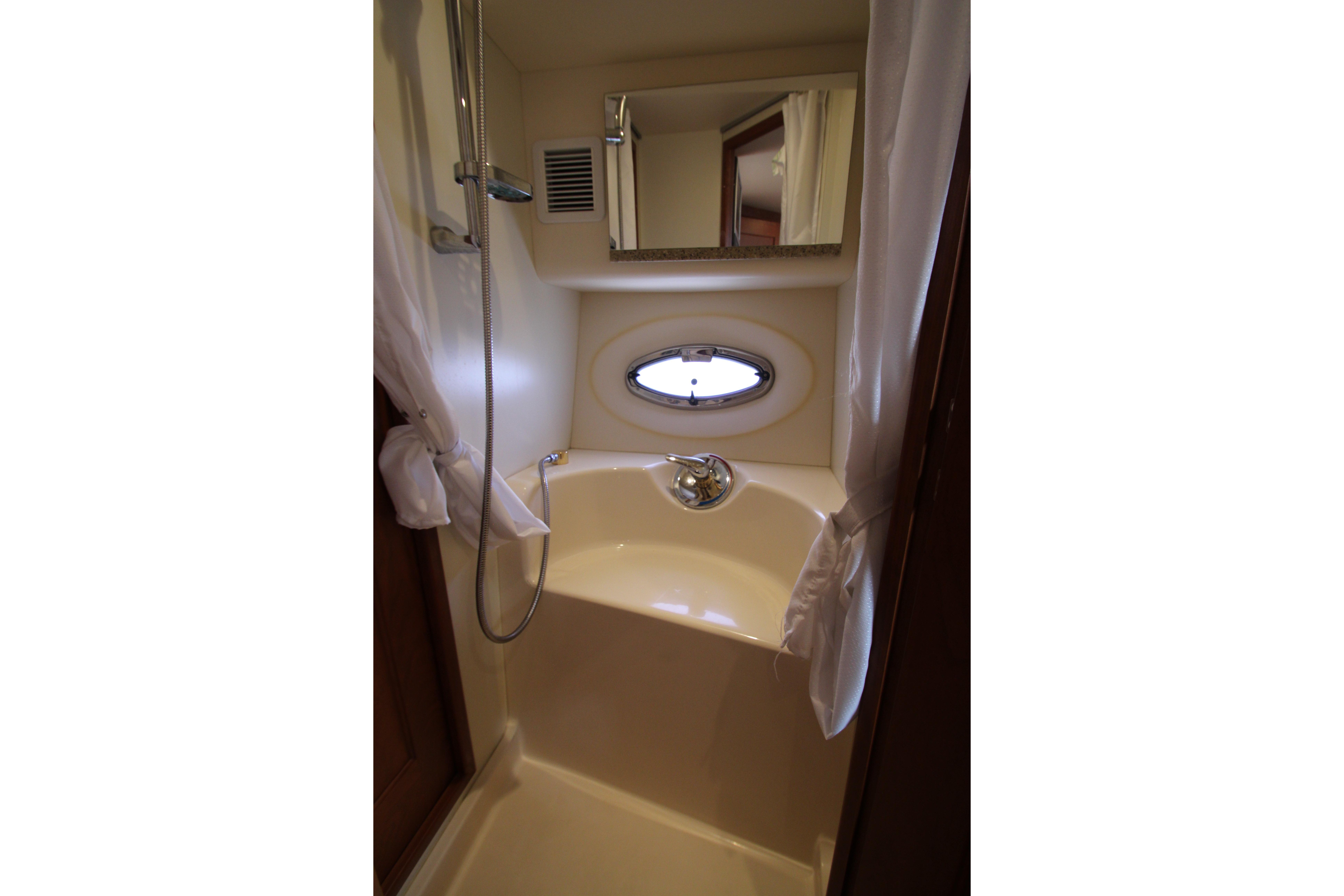 Compact bathroom with shower in 2006 Silverton 38 Sport Bridge yacht.
