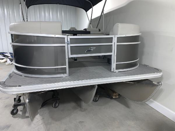 2024 Starcraft EX22 FD pontoon boat in a showroom.