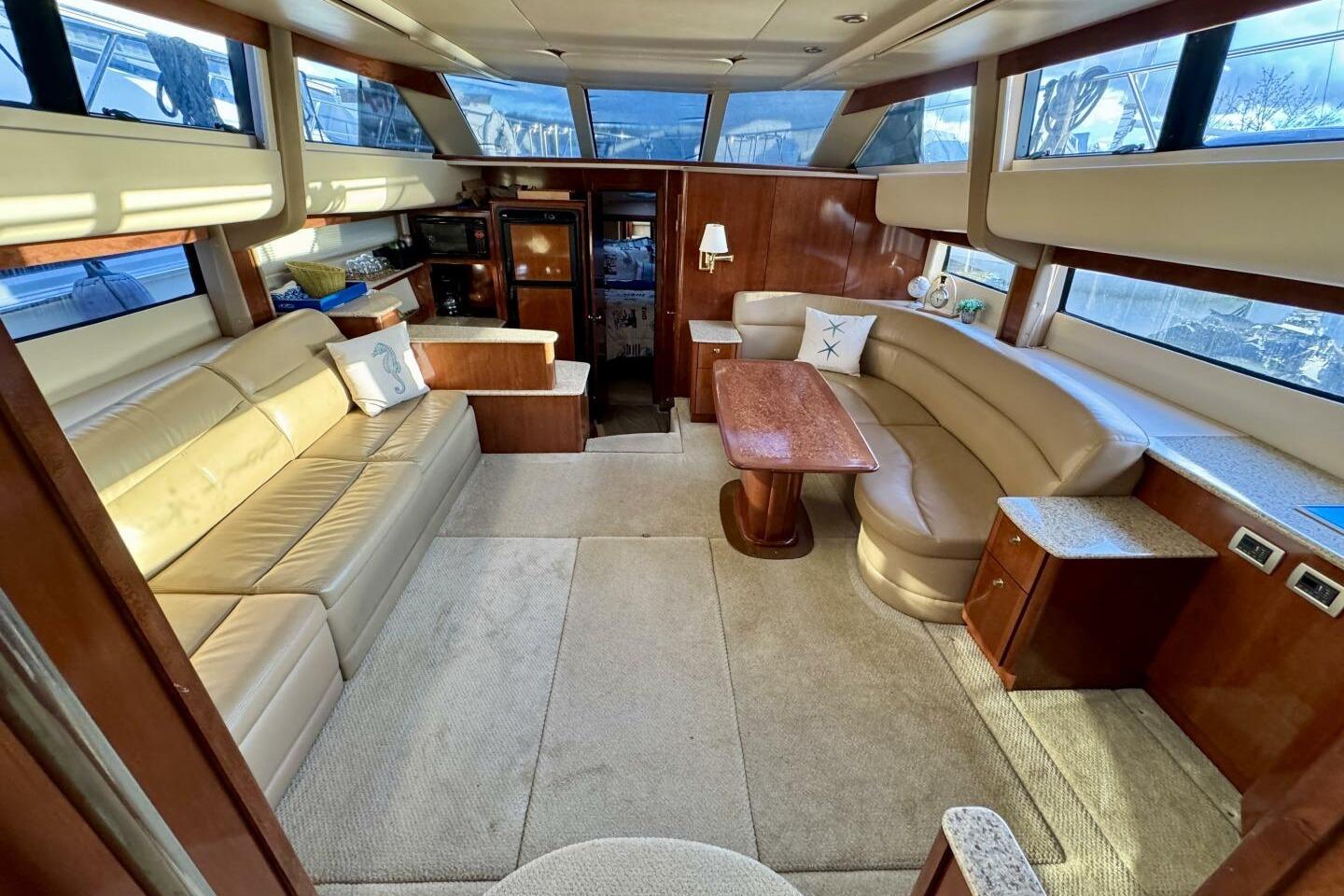 Luxurious interior of 2008 Meridian 459 Motoryacht with plush seating and elegant wood finishes.