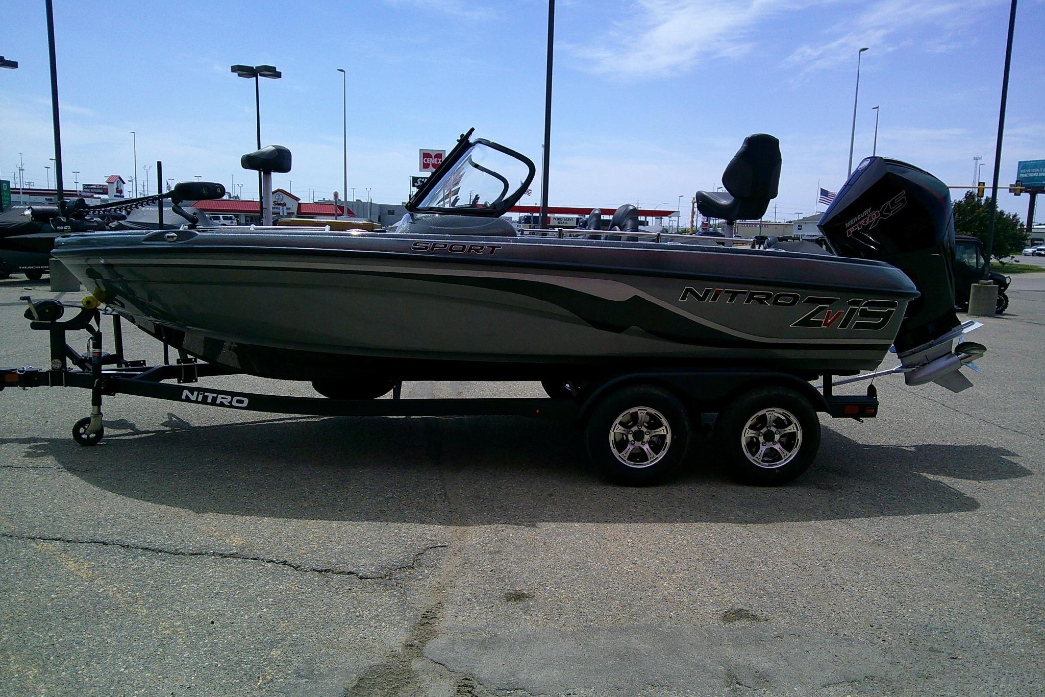 2026 Nitro ZV19 Sport boat on trailer in parking lot, side view.