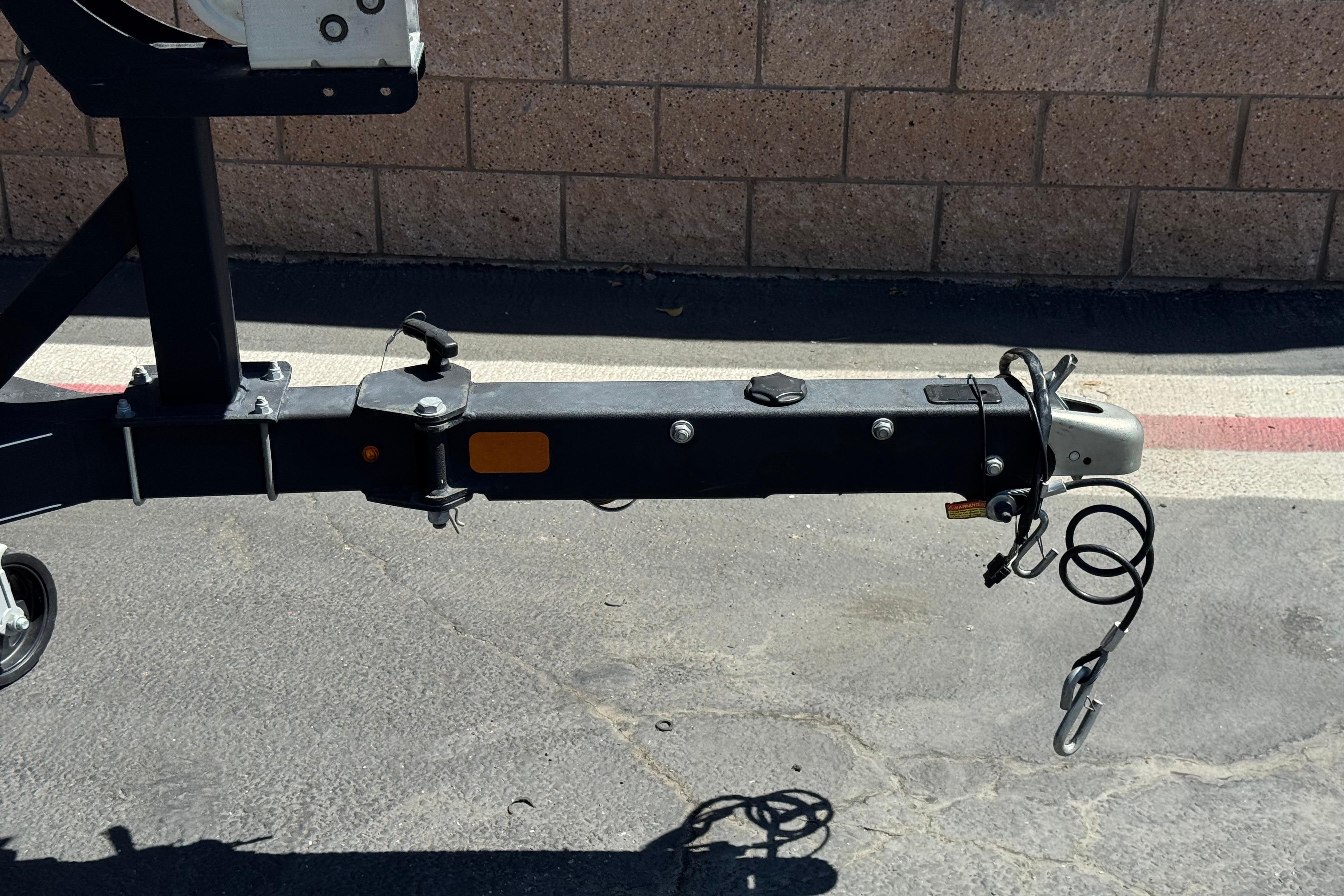 Trailer hitch of a 2017 Tahoe 2150 boat, parked on asphalt.