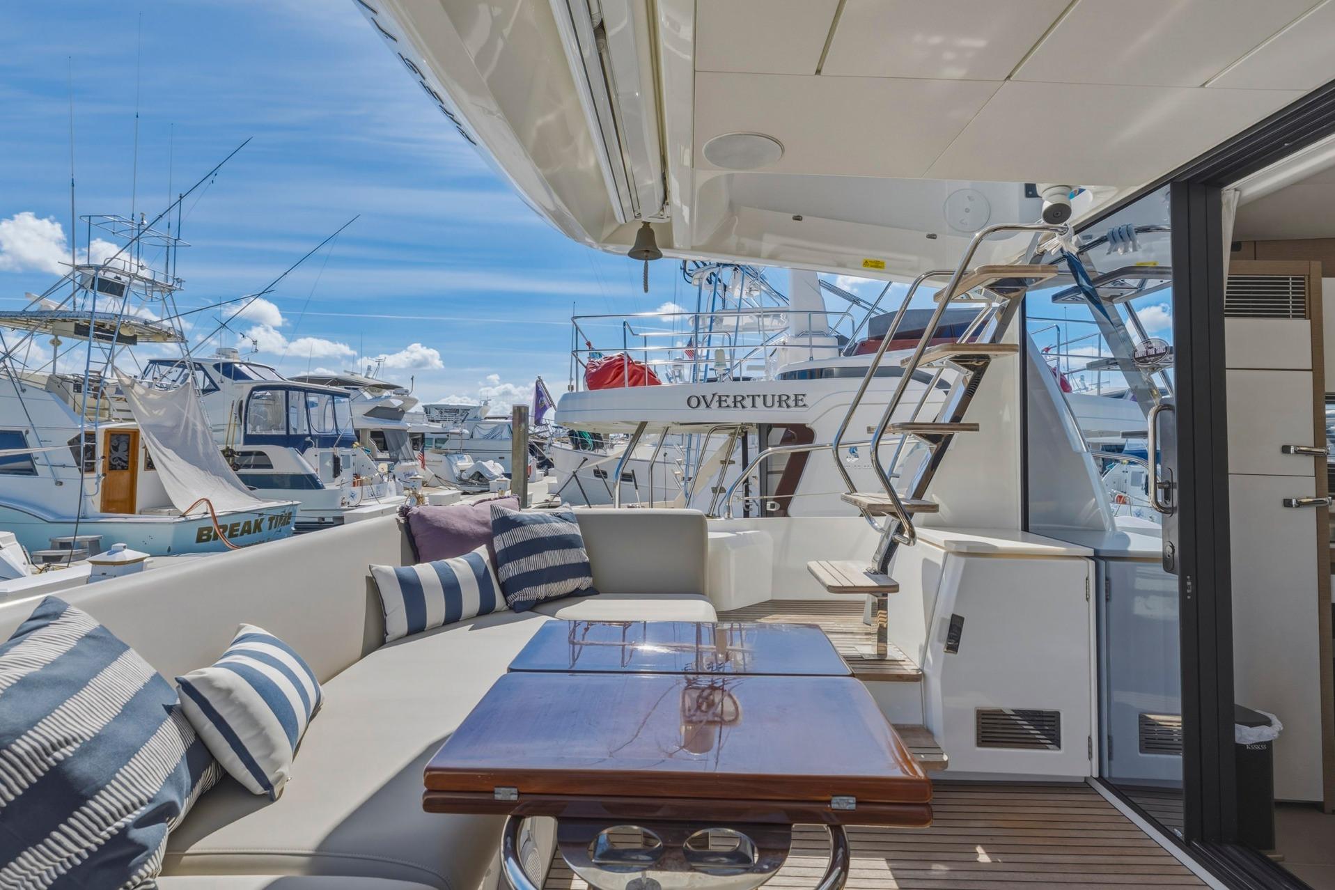 Luxurious 2022 Prestige 520 yacht interior with elegant seating and marina view.
