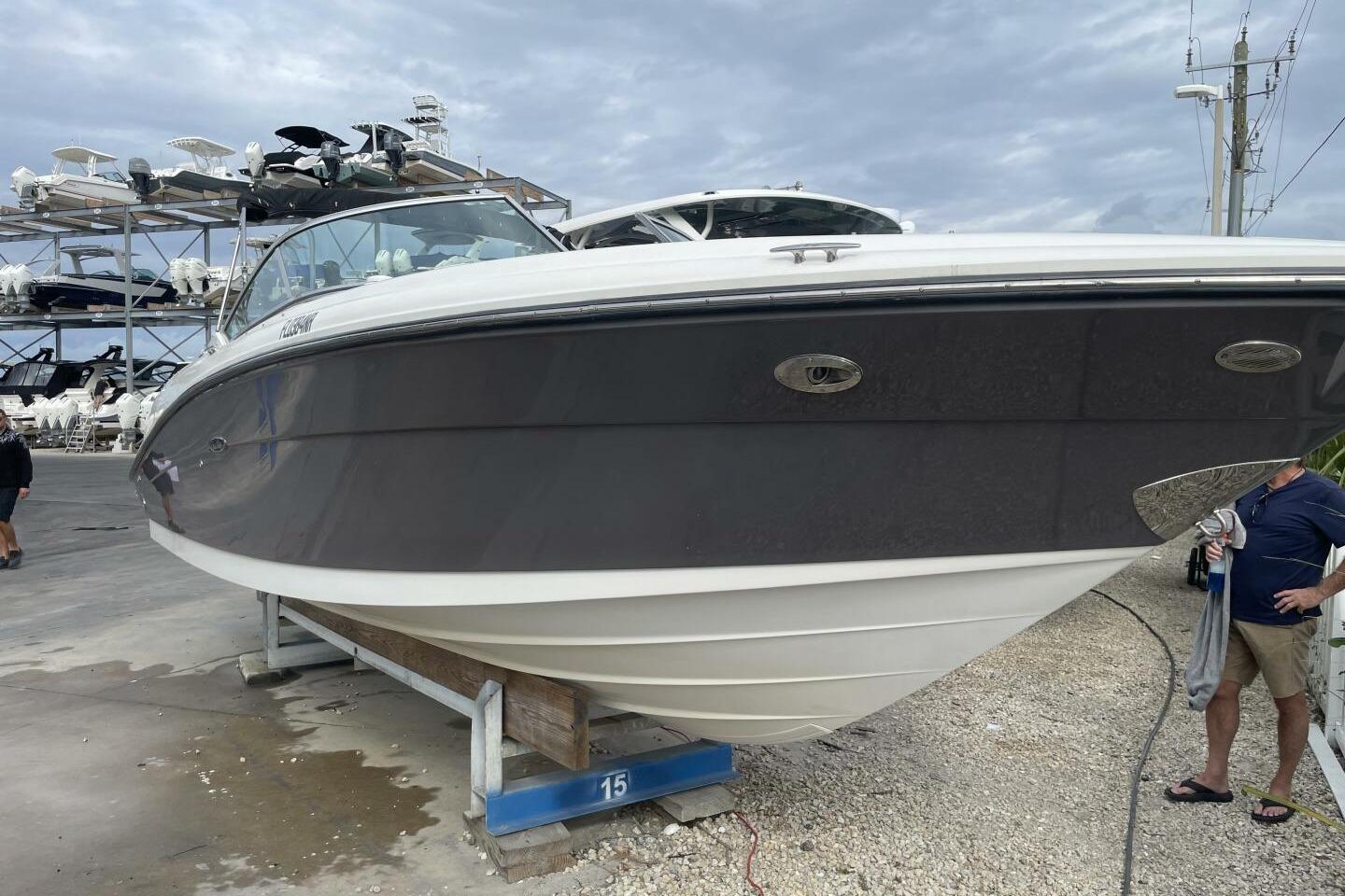 2008 Sea Ray 270 SLX boat on dry dock, cloudy sky background.