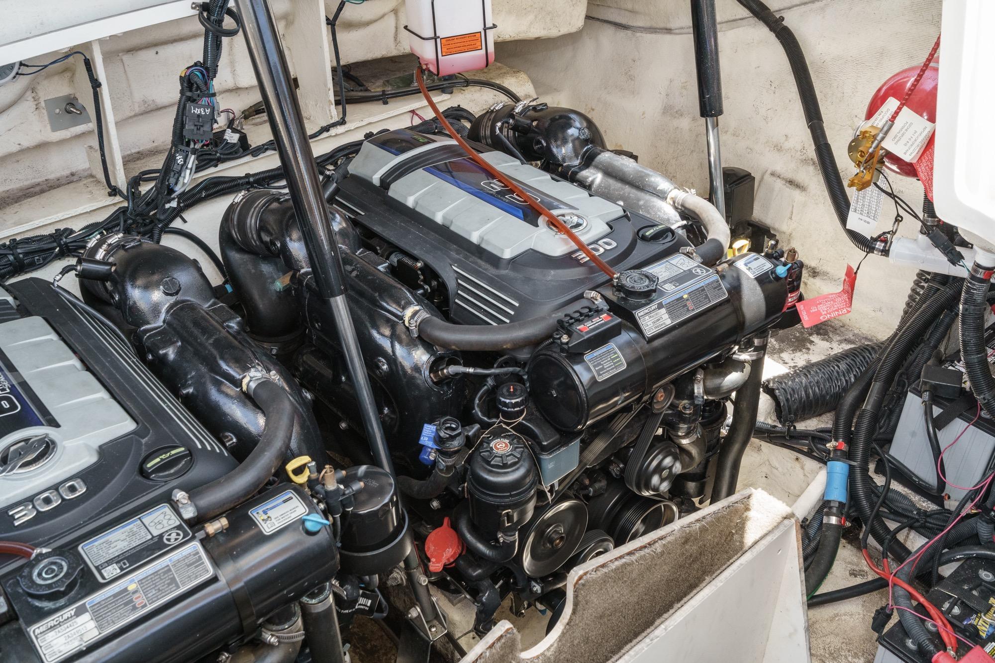 Engine compartment of a 2018 Sea Ray SLX 310 boat, showcasing dual Mercury engines.