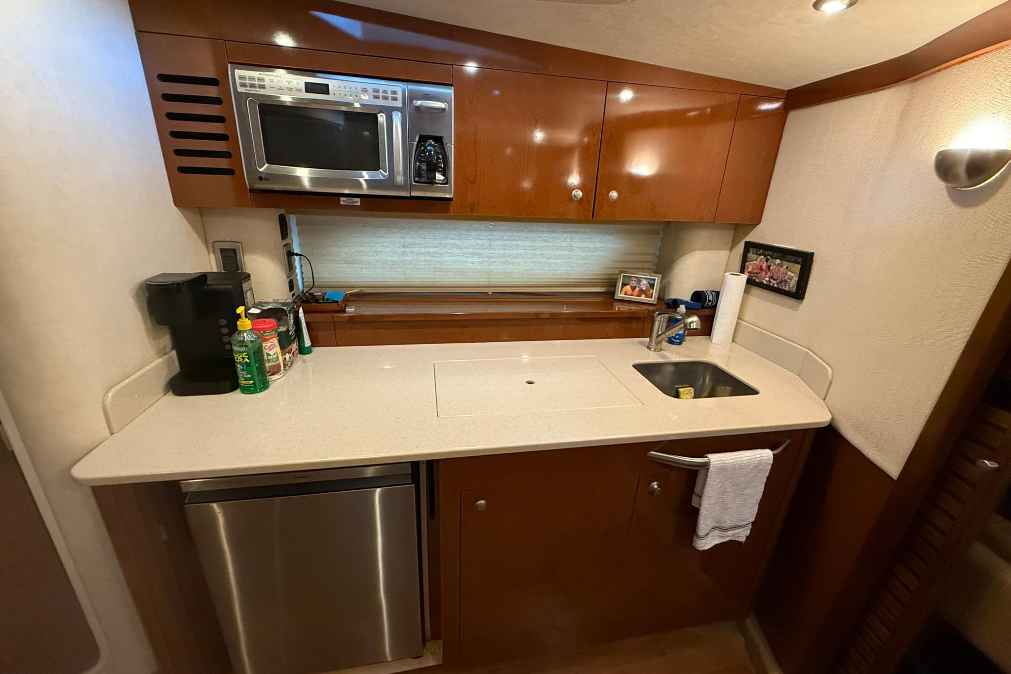 2009 Sea Ray 350 Sundancer yacht kitchen with modern appliances and sleek cabinetry.