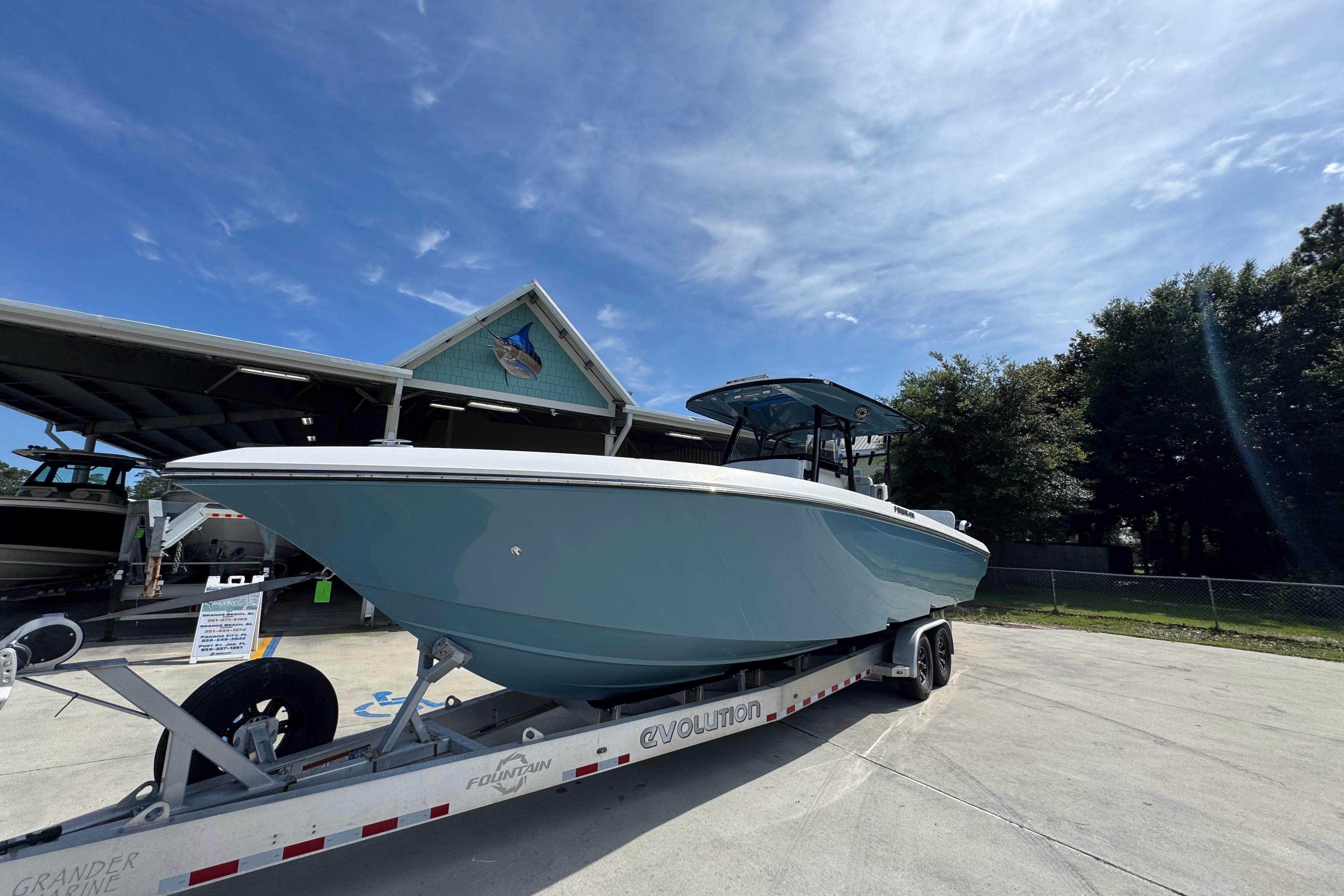 2023 Fountain 34 Tournament Edition boat on trailer under clear sky.