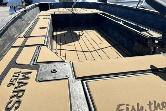 2026 Tracker Grizzly 1756 T Marsh boat interior with tan decking and storage compartments.