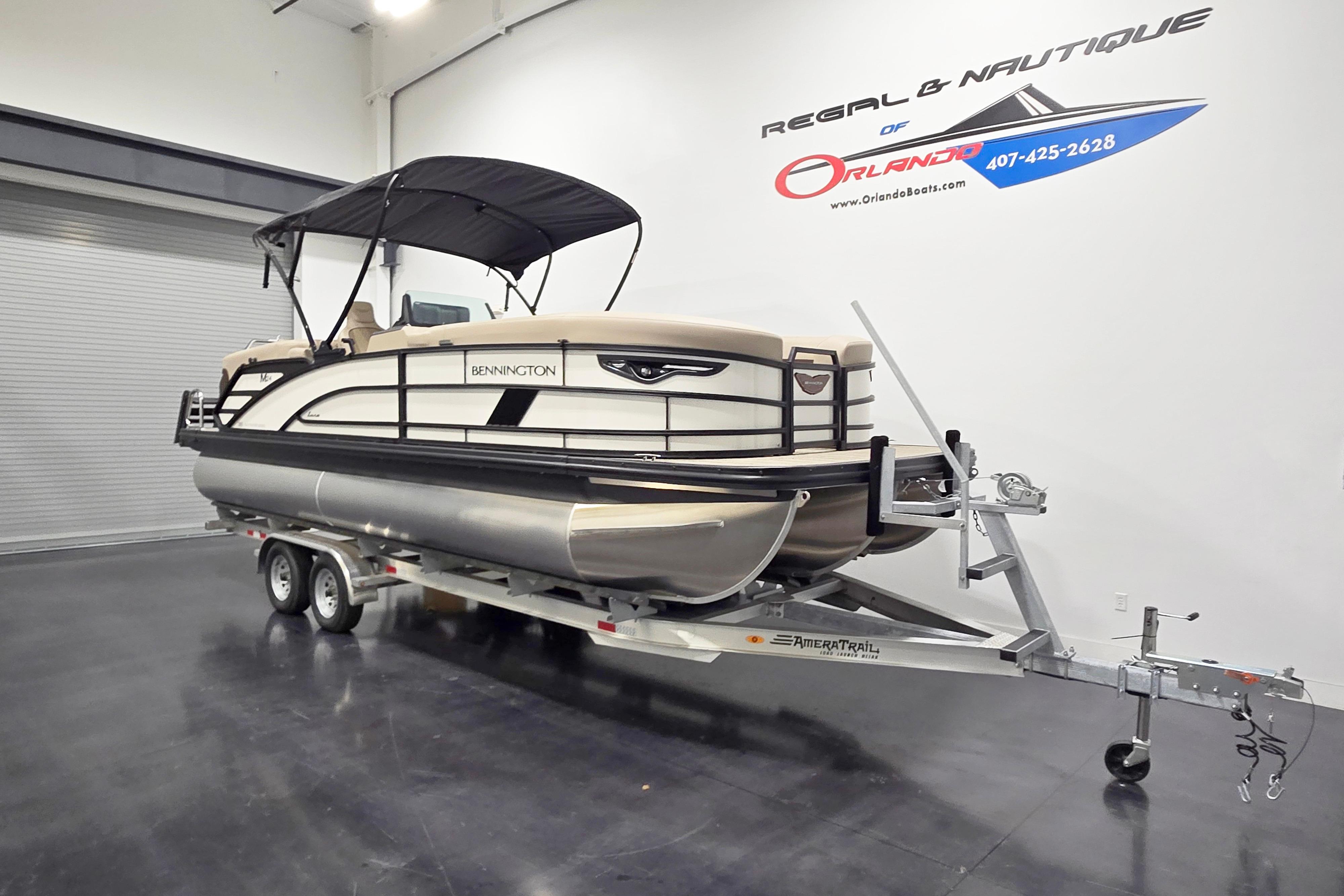 2026 Bennington 24 M pontoon boat on trailer in showroom.