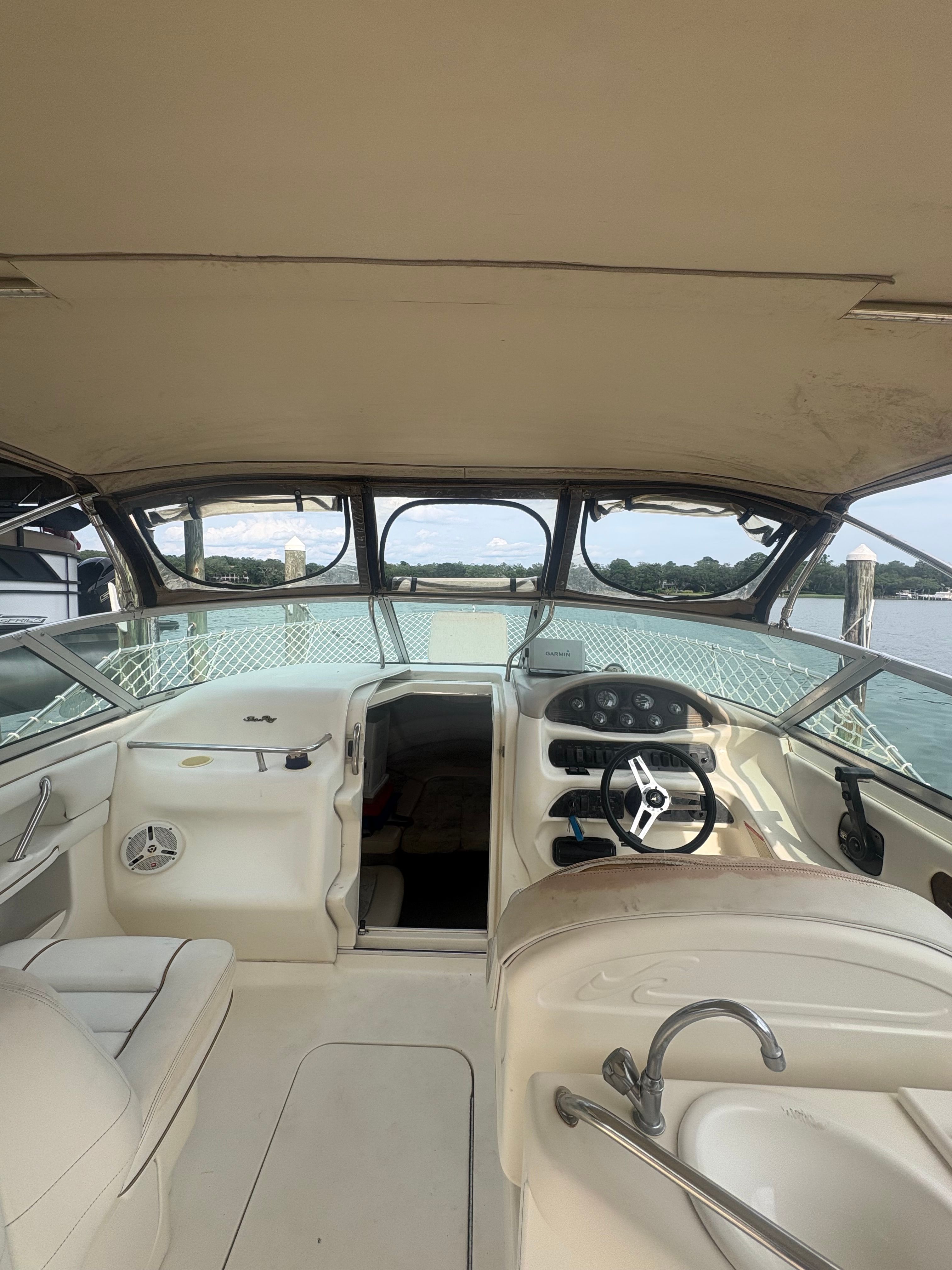 Interior view of a 1996 Sea Ray 280 Cuddy Cabin with helm and seating area.