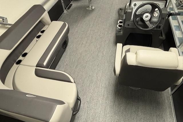 Interior of 2026 Sun Tracker Bass Buggy 18 DLX pontoon boat with seating and steering console.