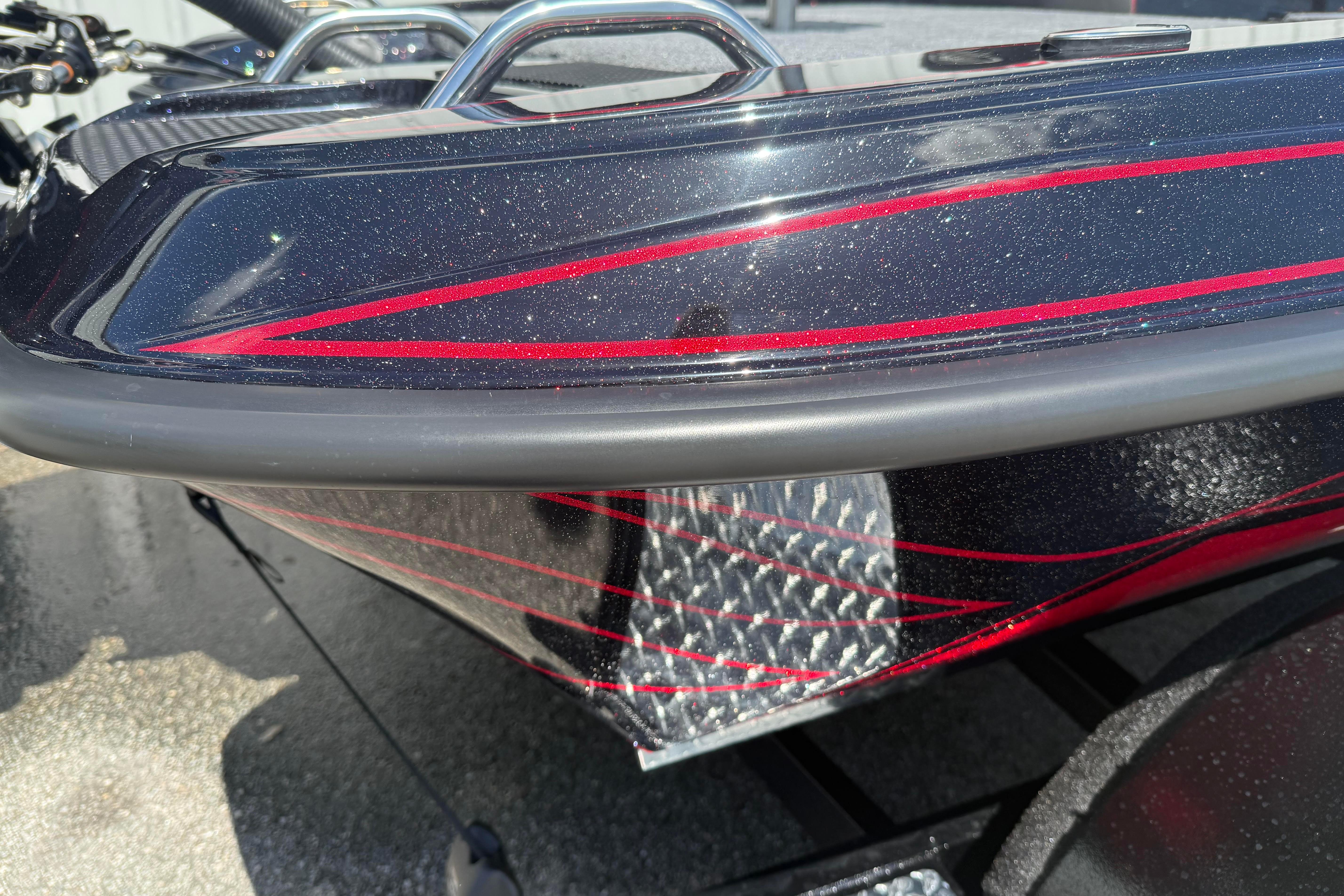 Close-up of 2027 Phoenix 919 ZXL boat with sleek black and red design.