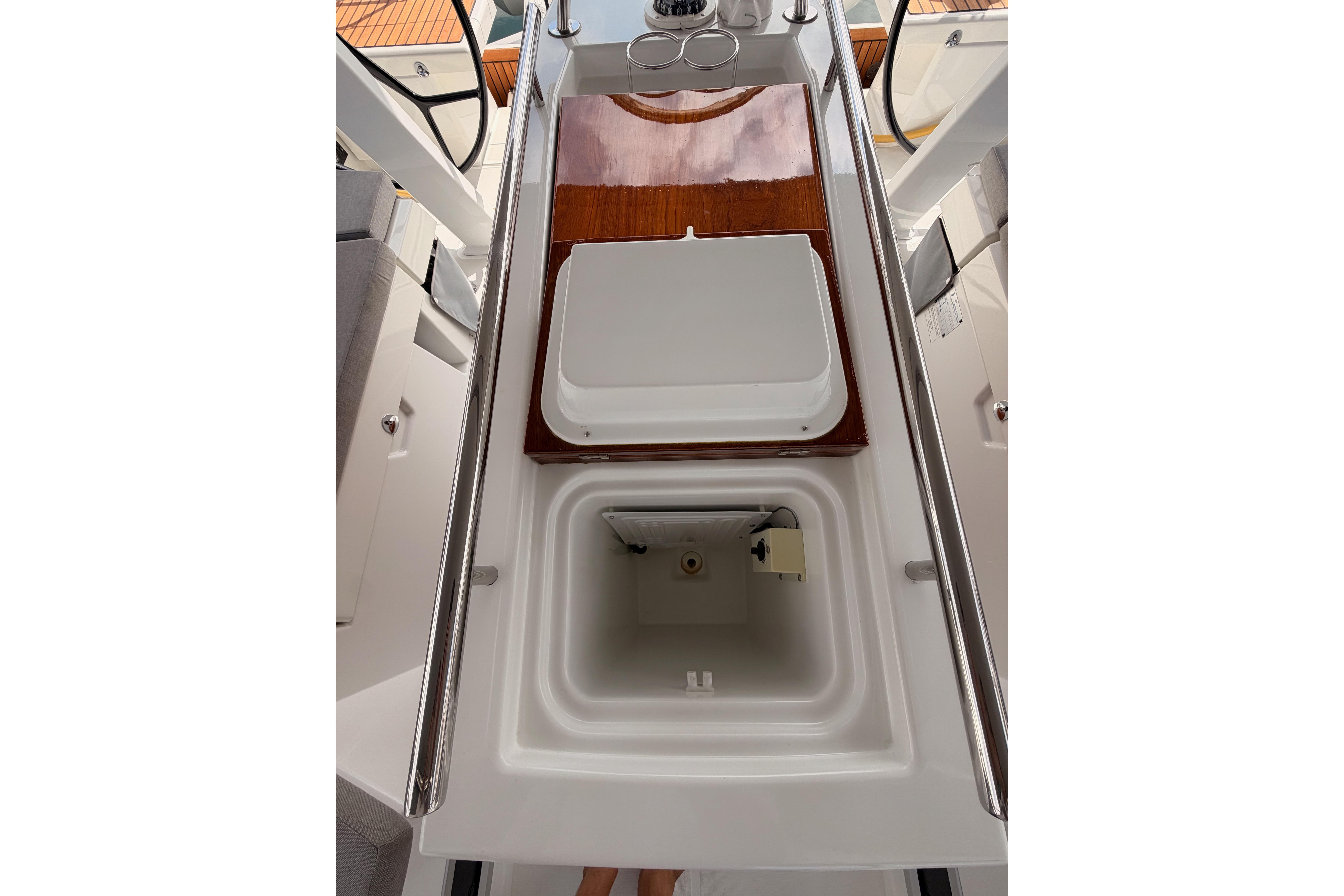 Cockpit view of 2020 Beneteau Oceanis 46.1 sailboat with open storage compartment.