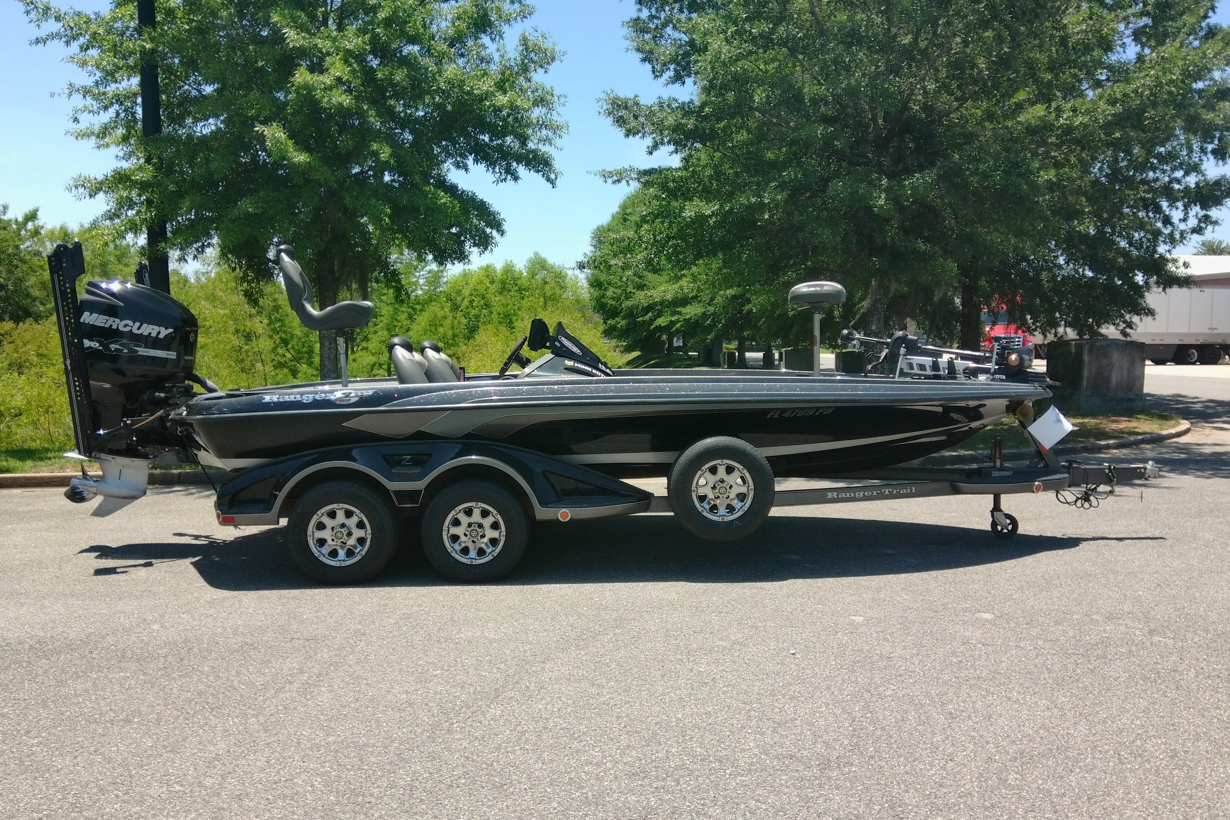2012 Ranger Z520 boat on trailer, parked outdoors with trees in the background.