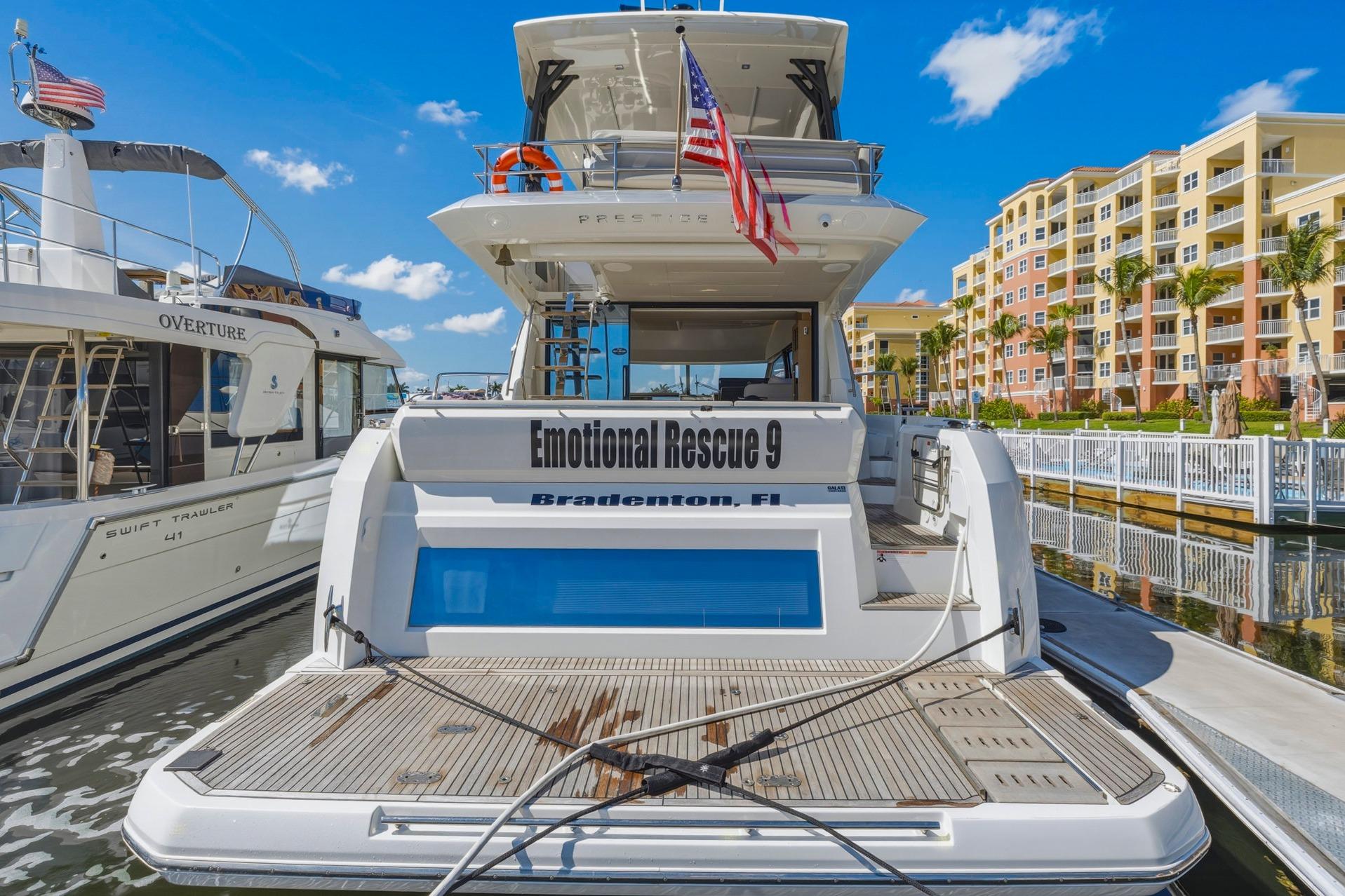 Luxury Prestige 520 yacht docked, featuring "Emotional Rescue 9" in Bradenton, Florida, 2022 model.