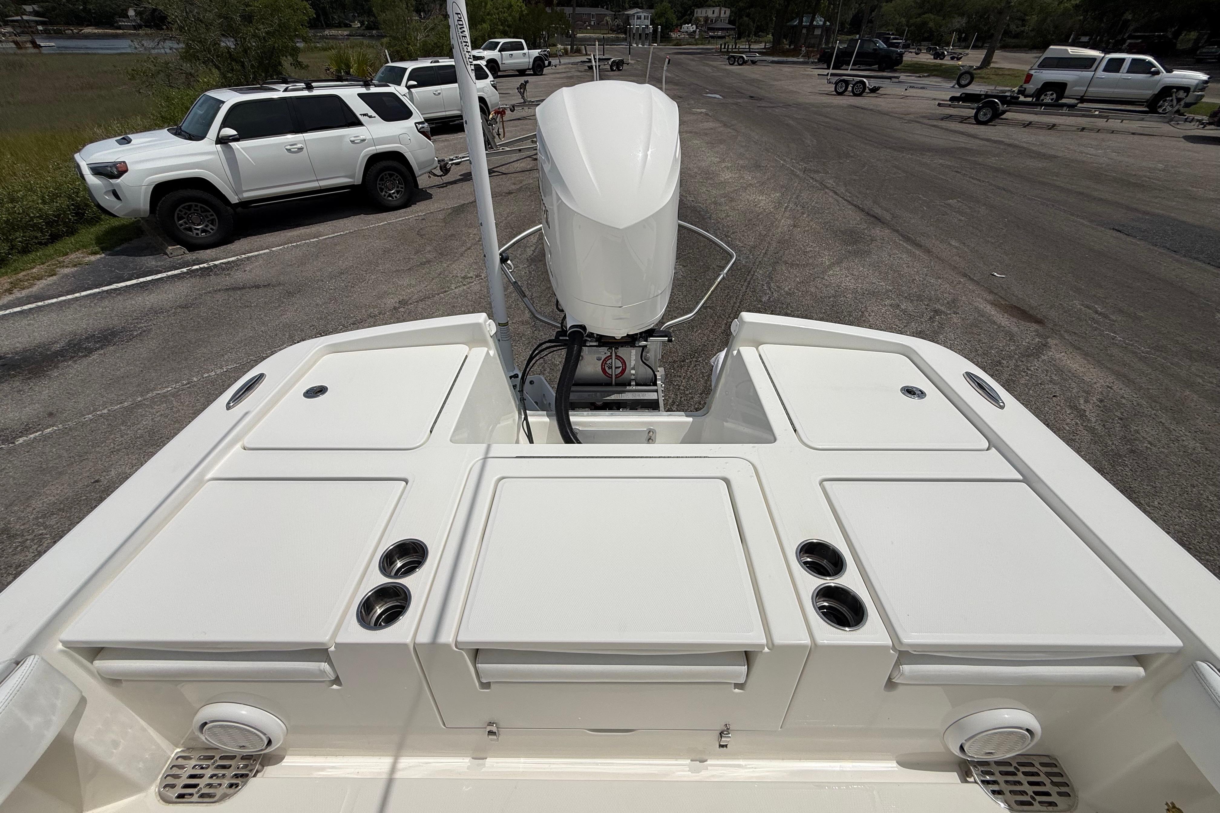 2019 Regulator 26XO boat with outboard motor at a parking area.