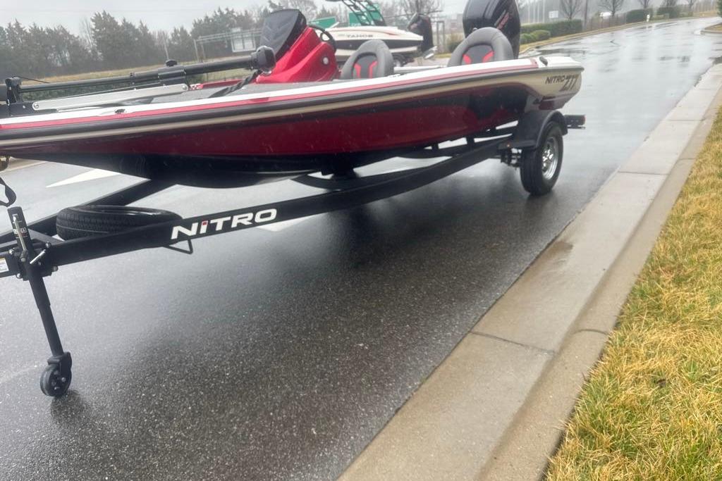 Red Nitro Z17 boat on trailer, parked on wet road, 2026 model.