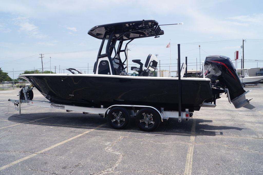 2027 Tidewater 2500 Carolina Bay boat on trailer, black hull, parked outdoors.