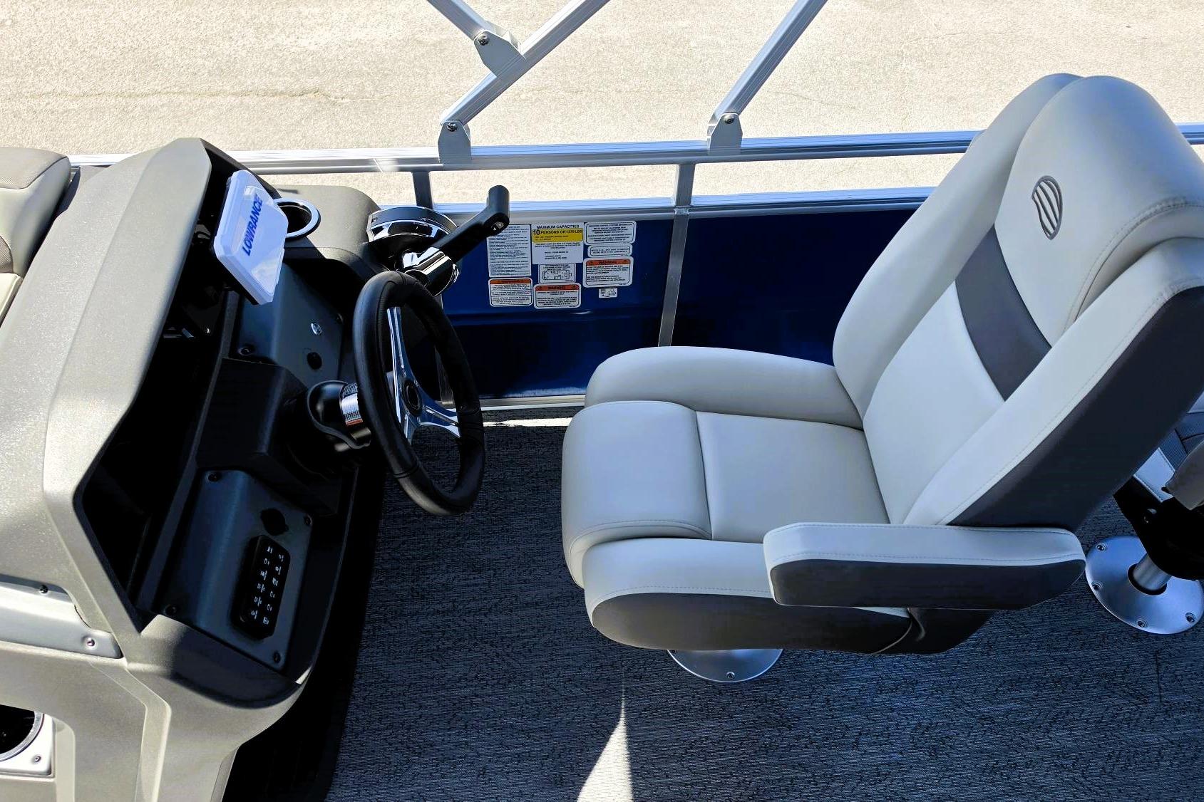2026 Sun Tracker Fishin' Barge 20 DLX helm with comfortable captain's chair and steering wheel.