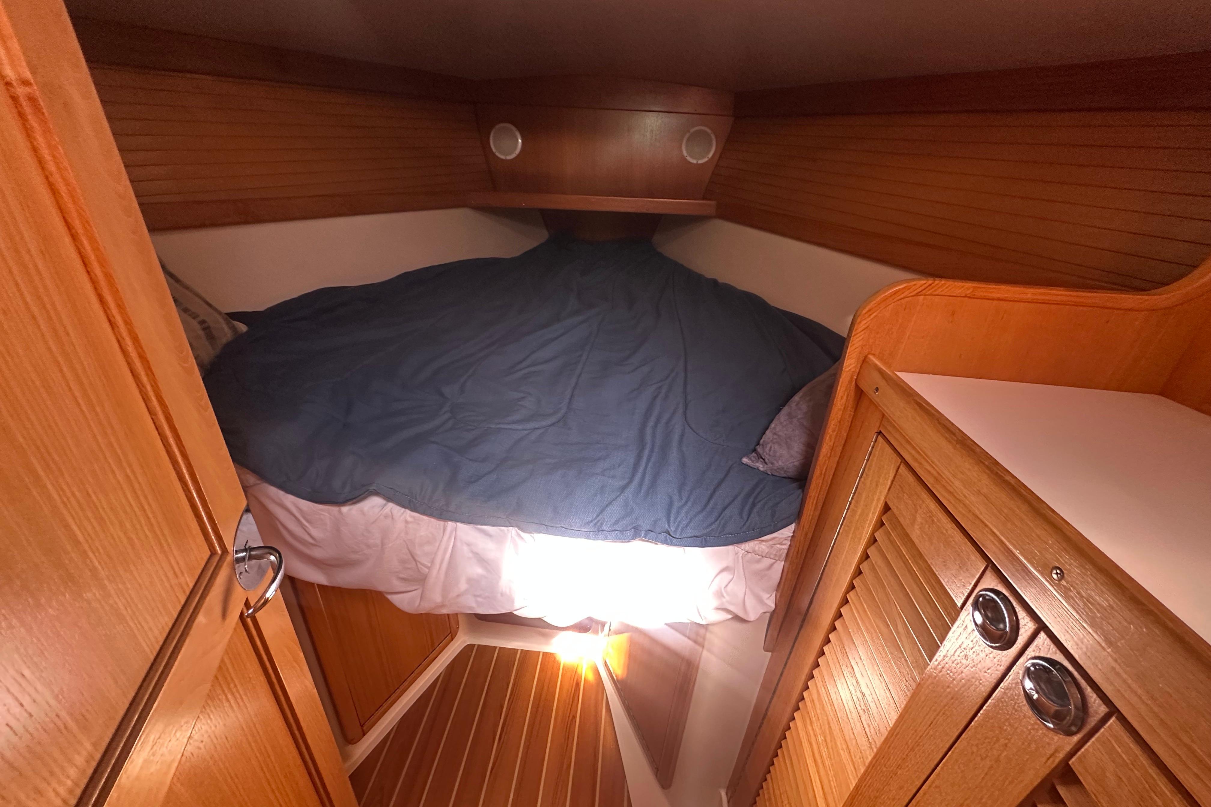 Cozy cabin interior of 2005 Catalina 36 MkII sailboat with wooden finishes and bed.