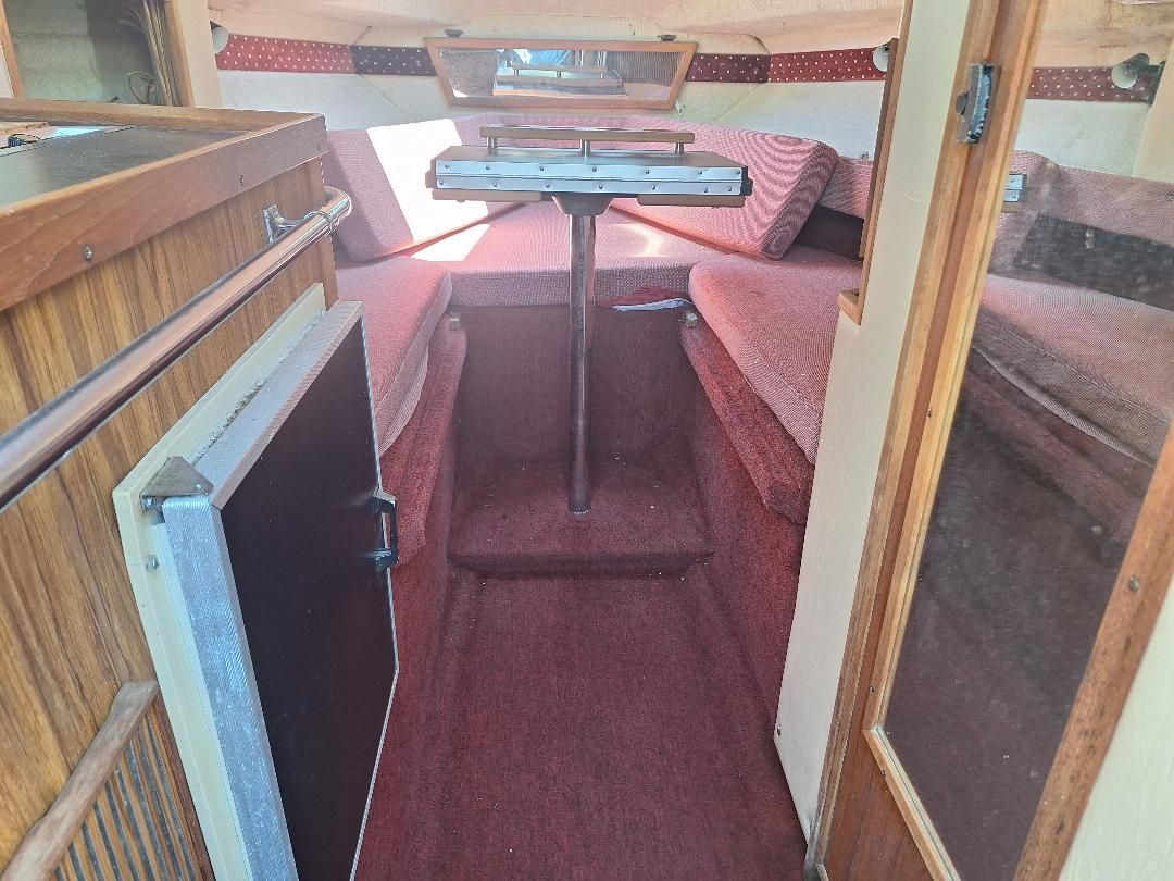 Interior of a 1986 Sea Ray Weekender 230 with red carpet.