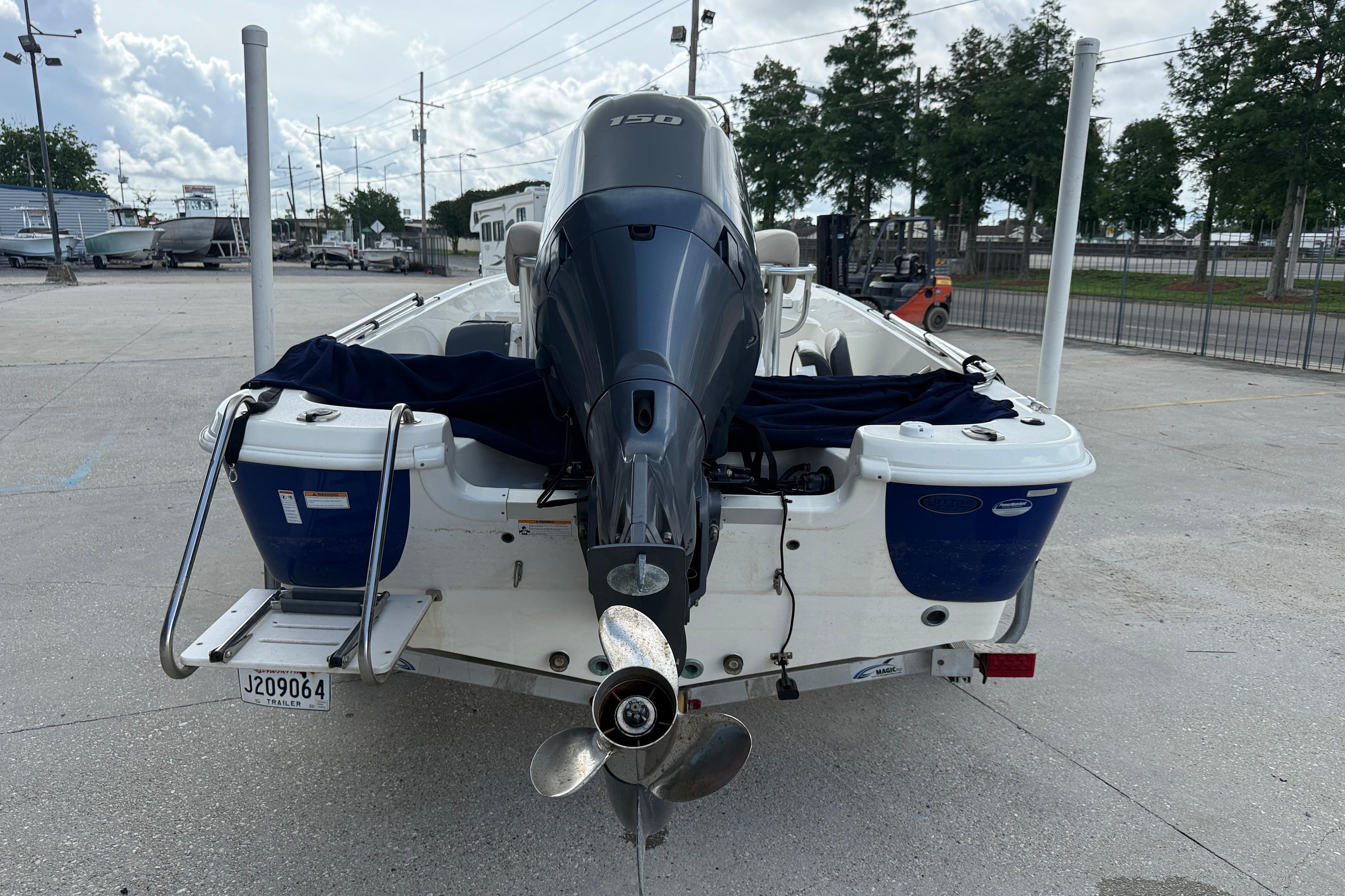 2017 NauticStar 1910 NauticBay boat with powerful outboard motor, parked on concrete.