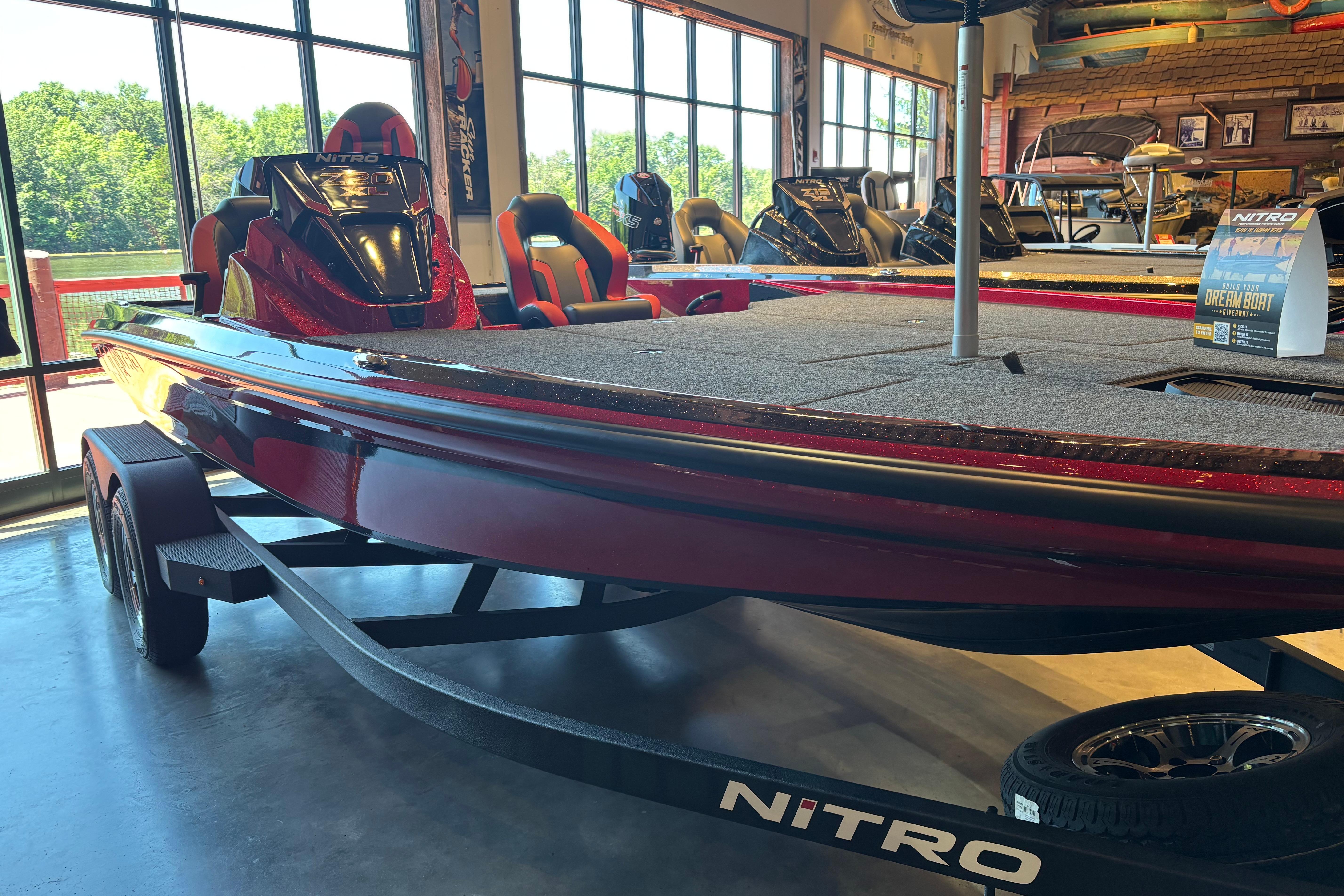 2026 Nitro Z20 XL Pro boat displayed in showroom, featuring sleek red design.