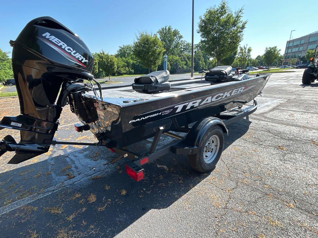 2025 Tracker Panfish 17 boat with Mercury engine on a trailer in a parking lot.