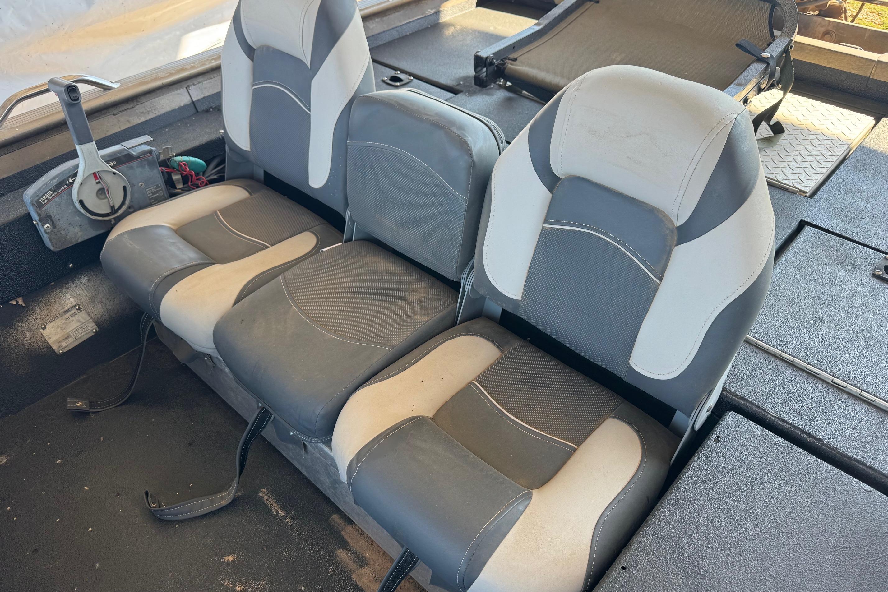 Three gray and white boat seats in a 2001 Xpress X51 model interior.