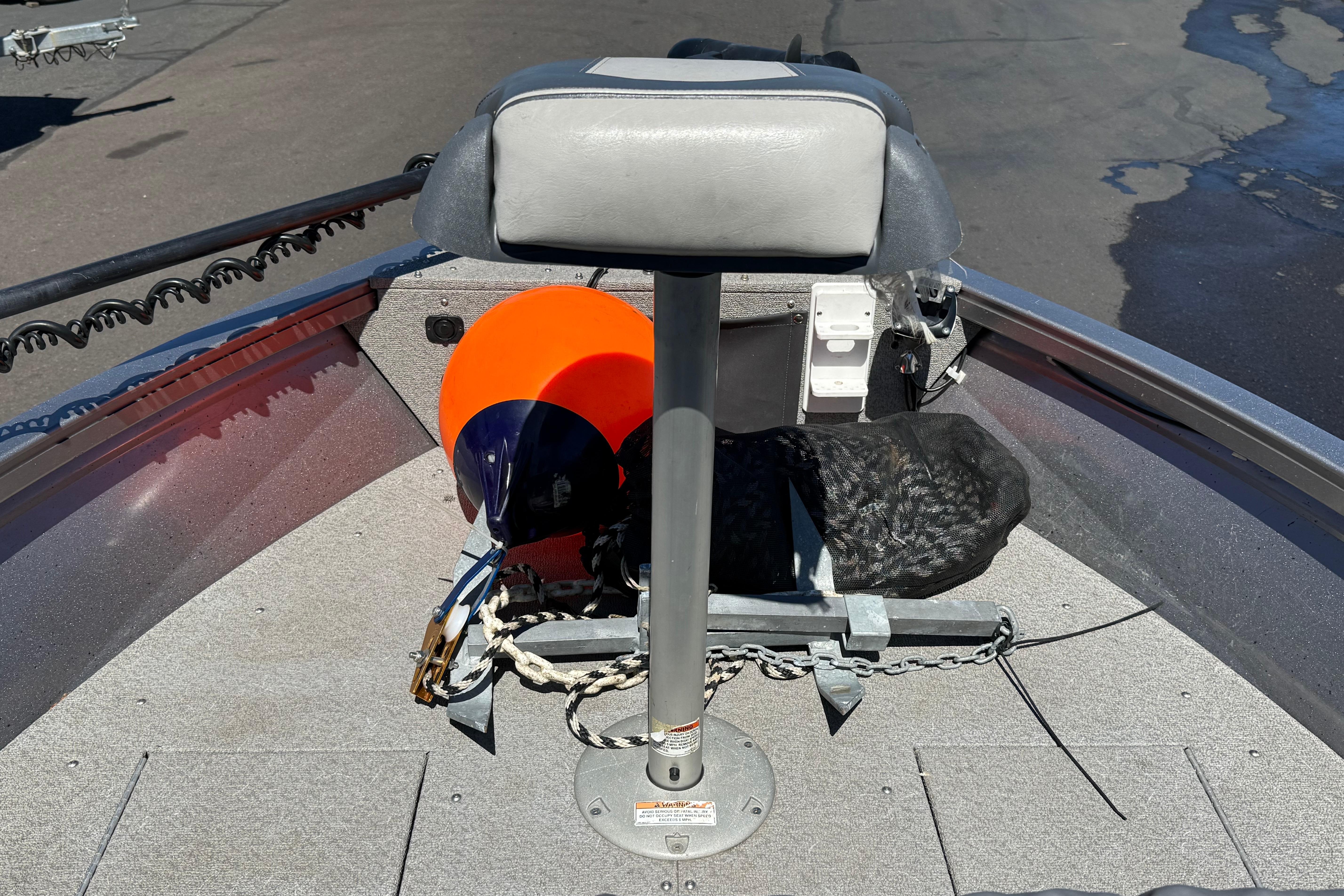 2016 Crestliner 1700 Vision boat bow with seat, safety gear, and anchor chain.