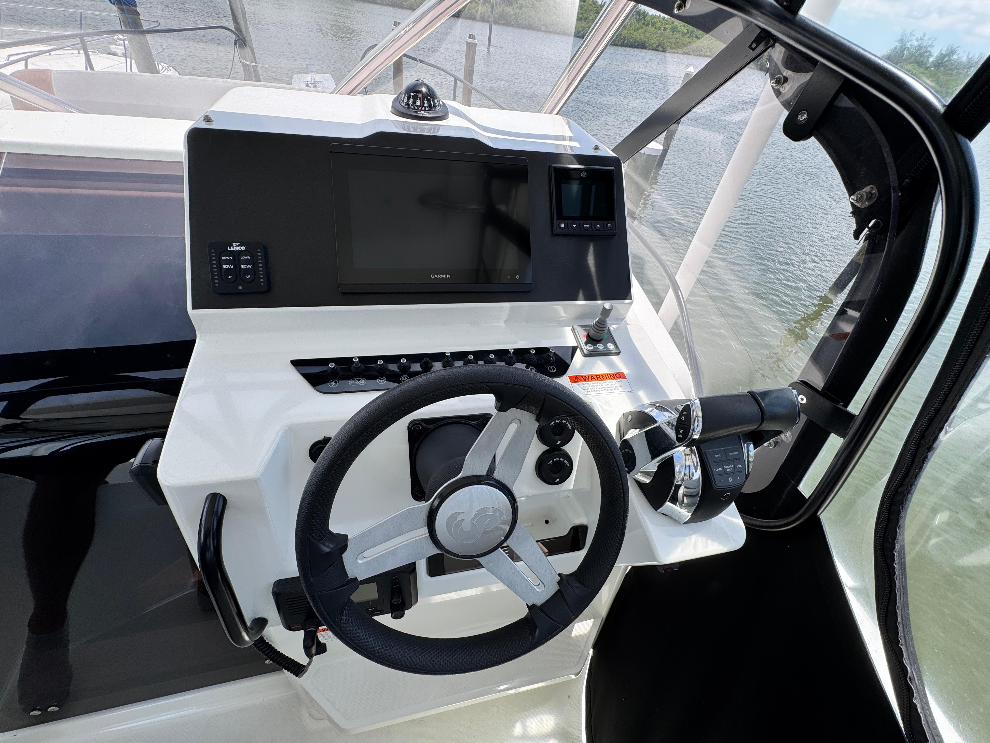 Helm of 2022 Beneteau Flyer 9 SUNdeck with steering wheel and navigation controls.