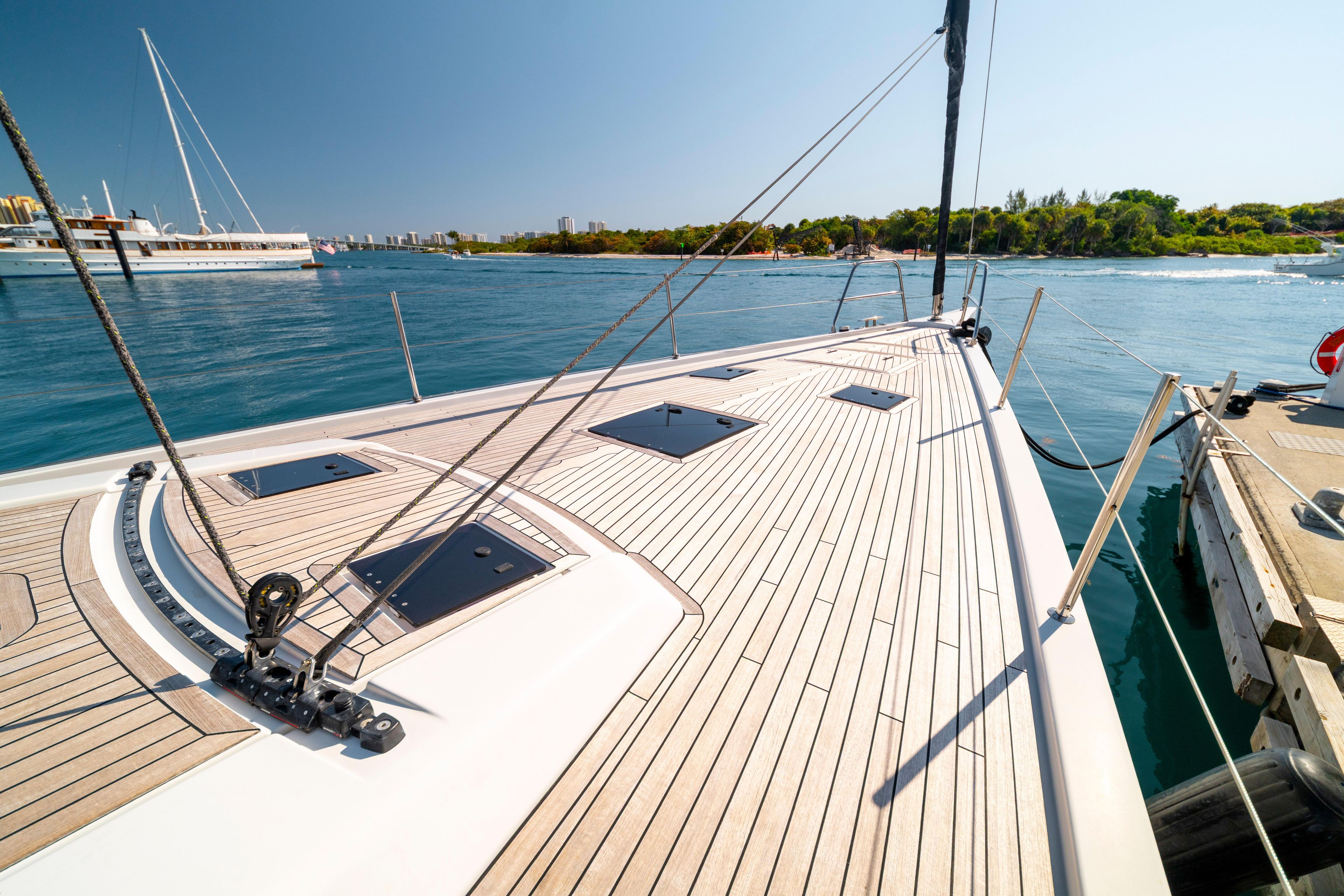 Deck view of 2016 Grand Soleil 58 yacht docked by the water.