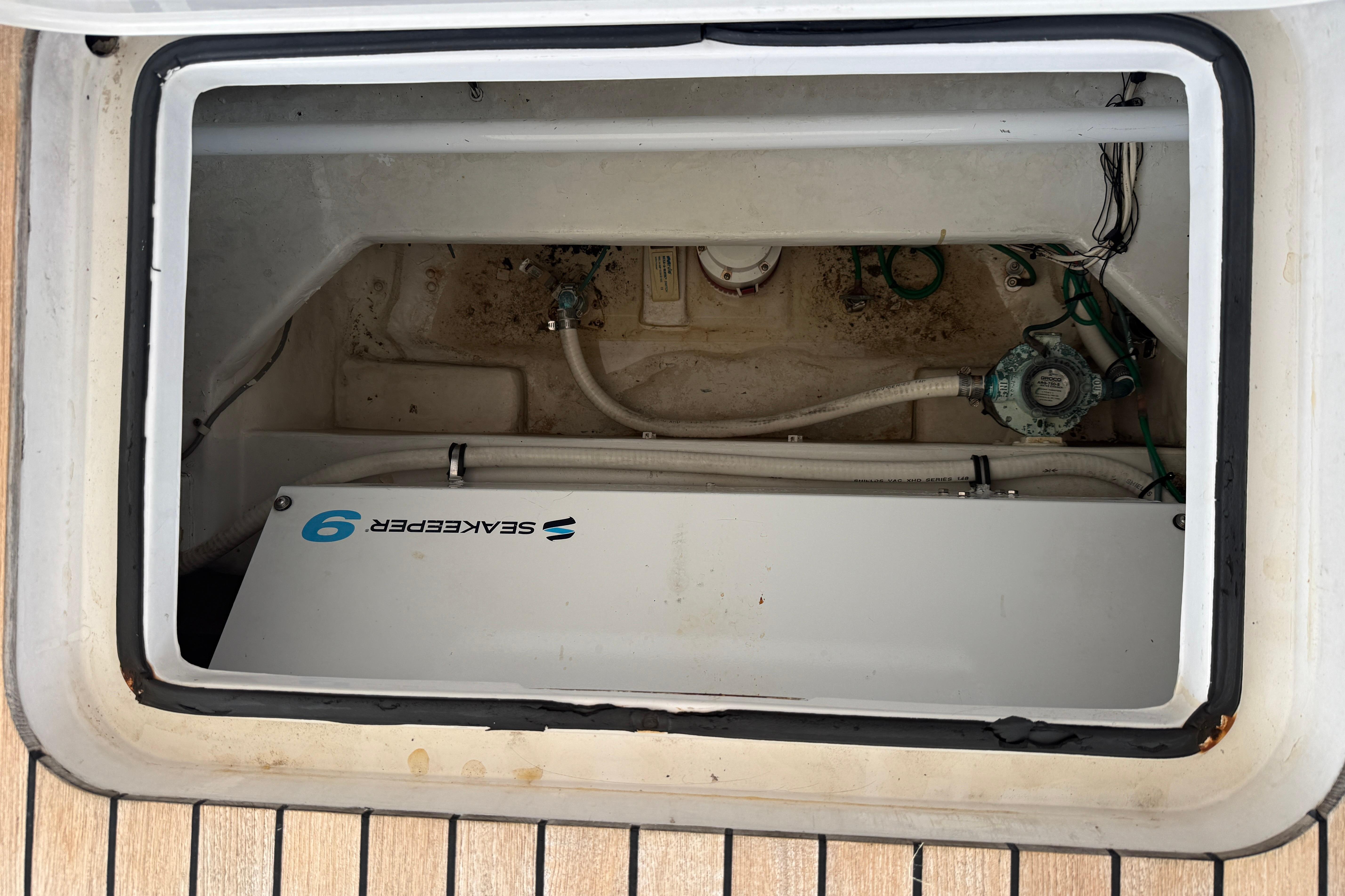 Engine compartment of a 2000 Viking 55 Convertible boat with Seakeeper 9 stabilizer.