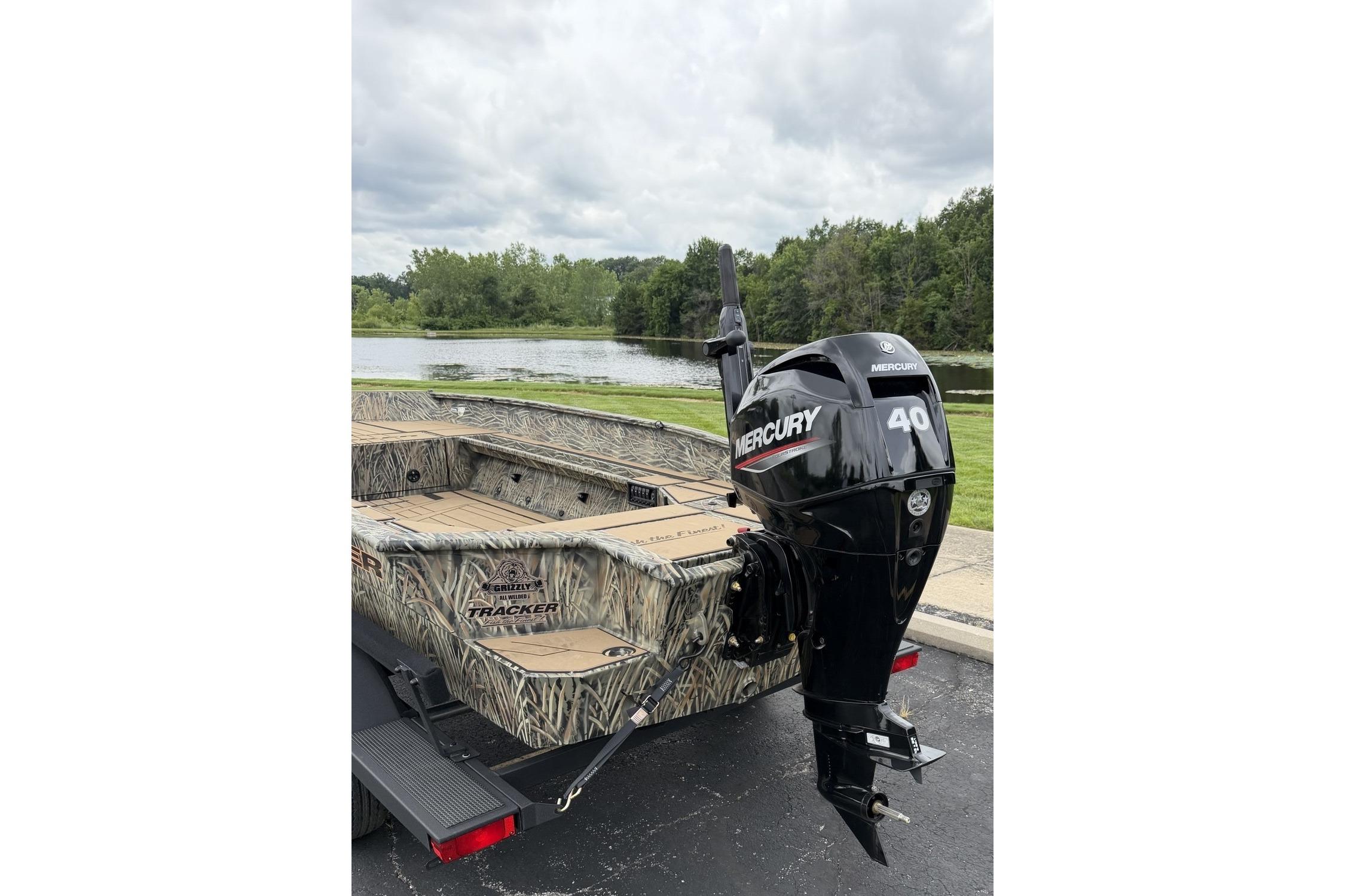 2026 Tracker Grizzly 1756 T Marsh boat with Mercury 40 outboard motor by a lake.