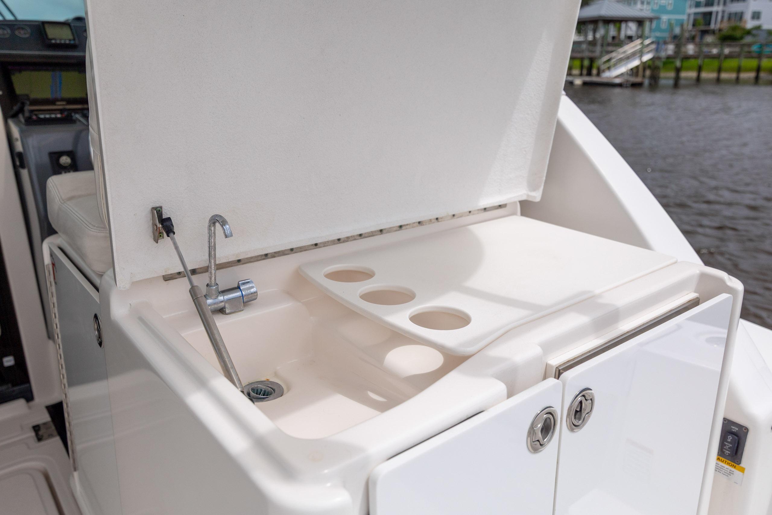 2004 Tiara Yachts 3200 Open boat sink and storage area by the water.