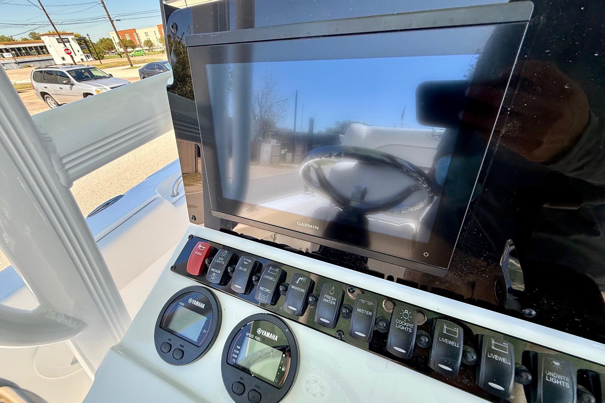Control panel of 2026 Sea Hunt Ultra 229 boat with Garmin display and Yamaha gauges.