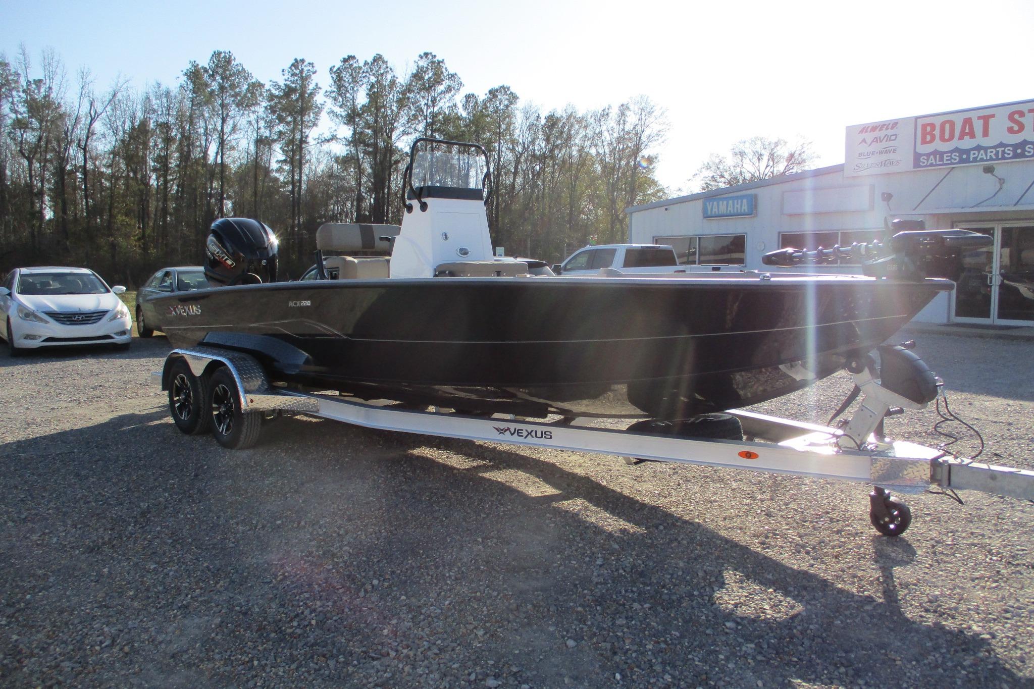2026 Vexus ACX2210 boat on trailer, parked outside a dealership.