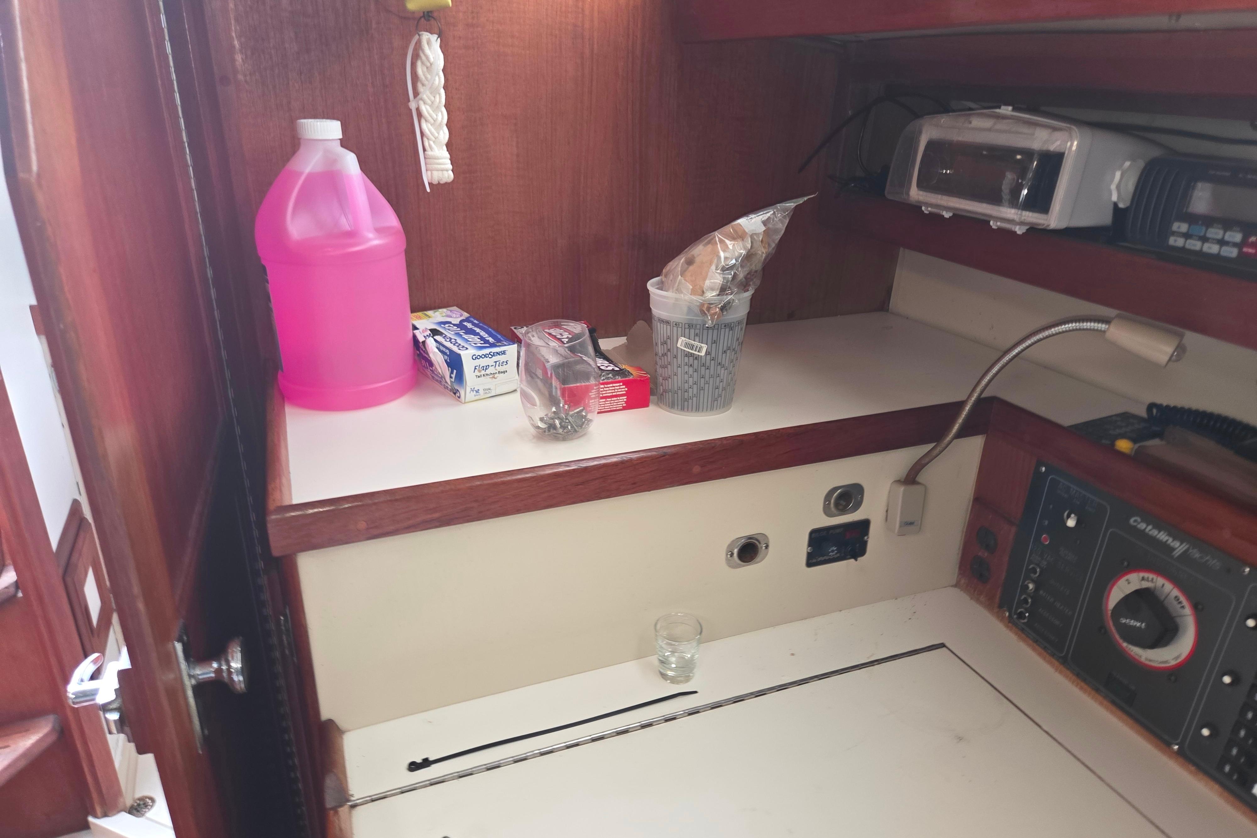 Interior of a 1986 Catalina 355 sailboat with various supplies on a counter.