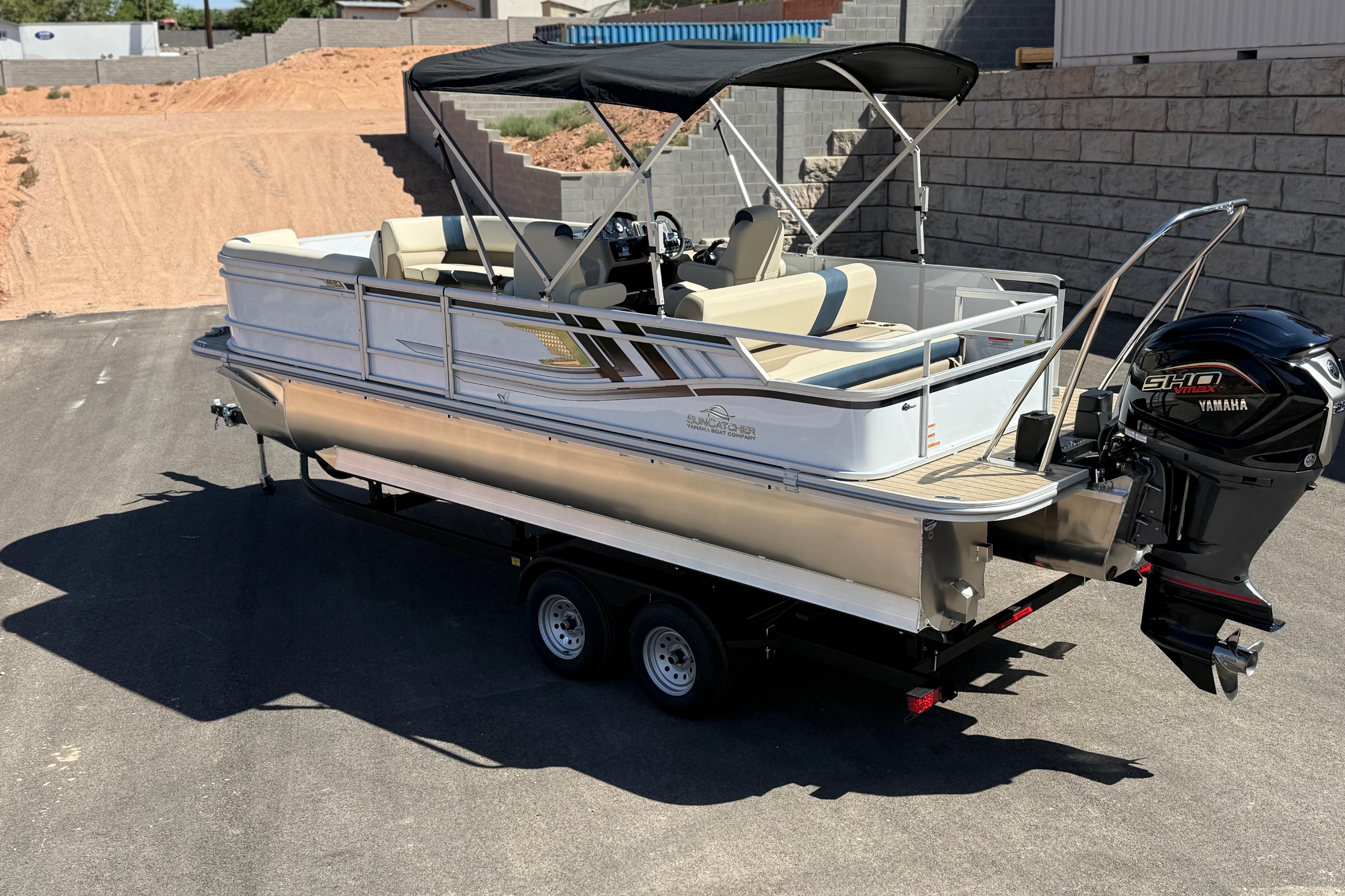 2026 SunCatcher Select 322SL pontoon boat with Yamaha motor on trailer.