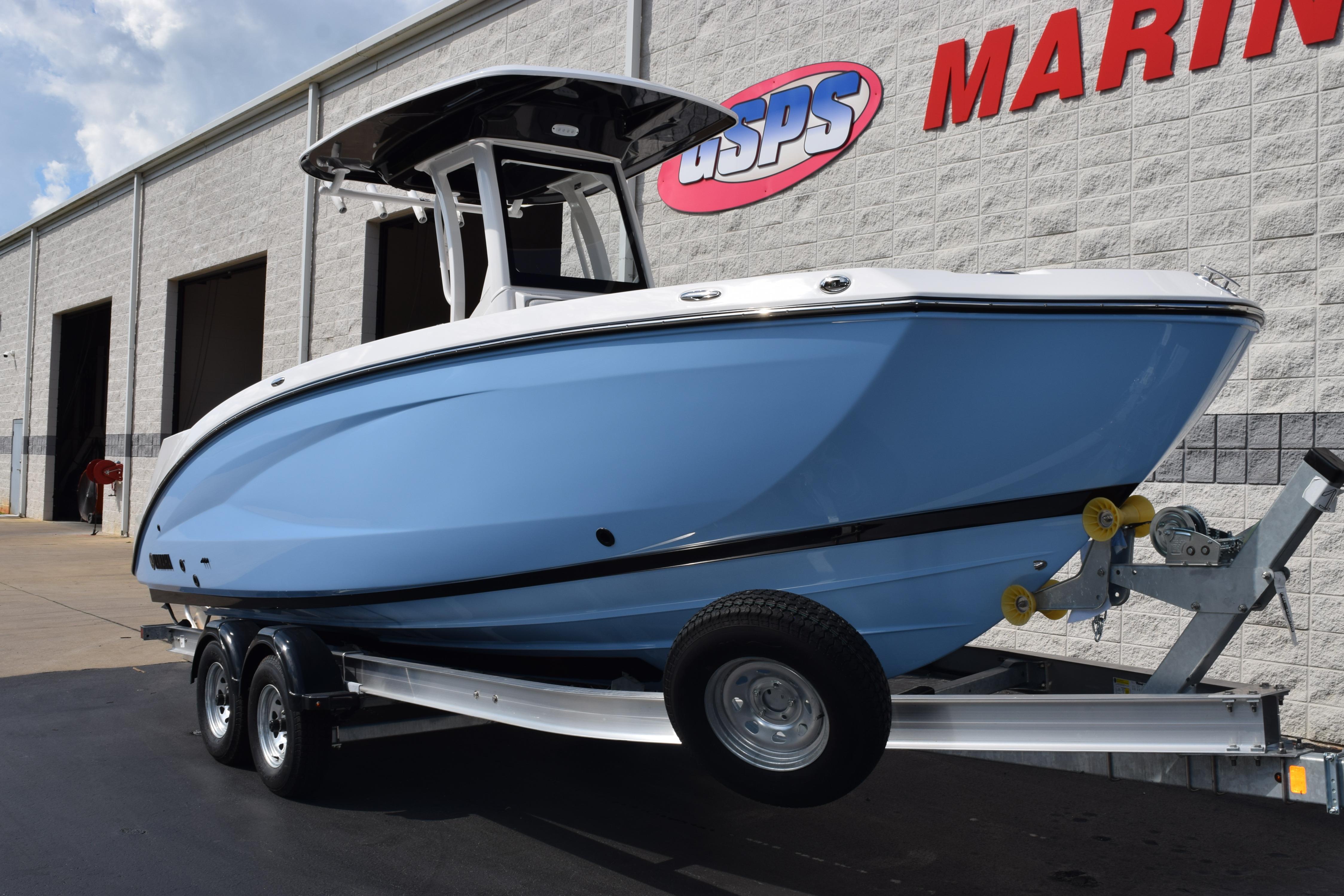 2026 Yamaha Boats 255 FSH Sport H on trailer outside marine dealership.