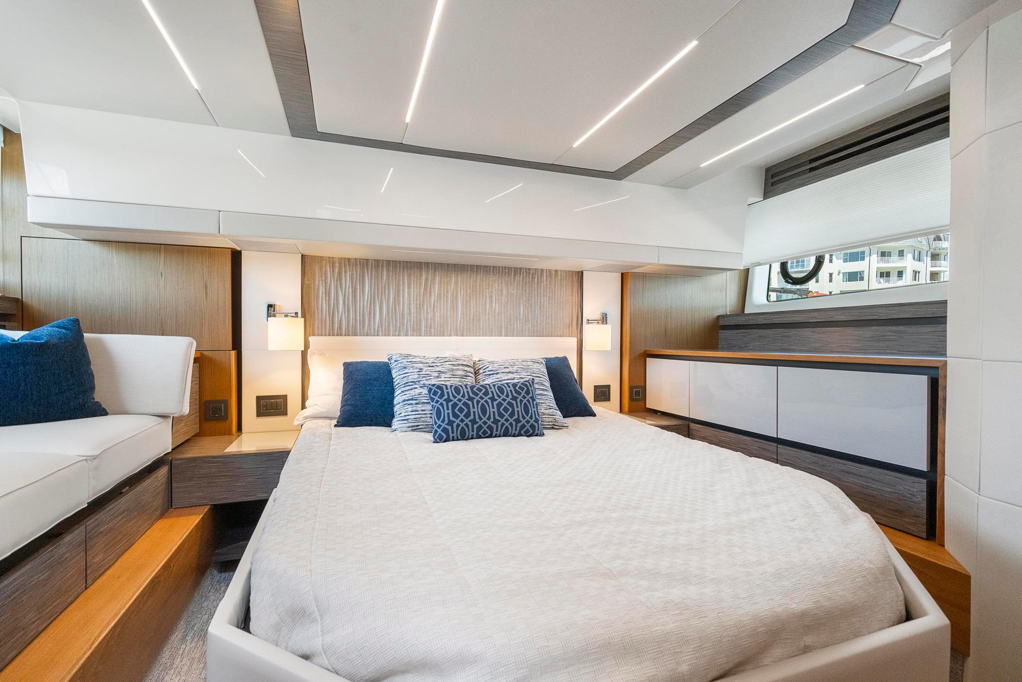 Luxurious bedroom interior of 2022 Tiara Yachts C49 Coupe with modern design and cozy bedding.