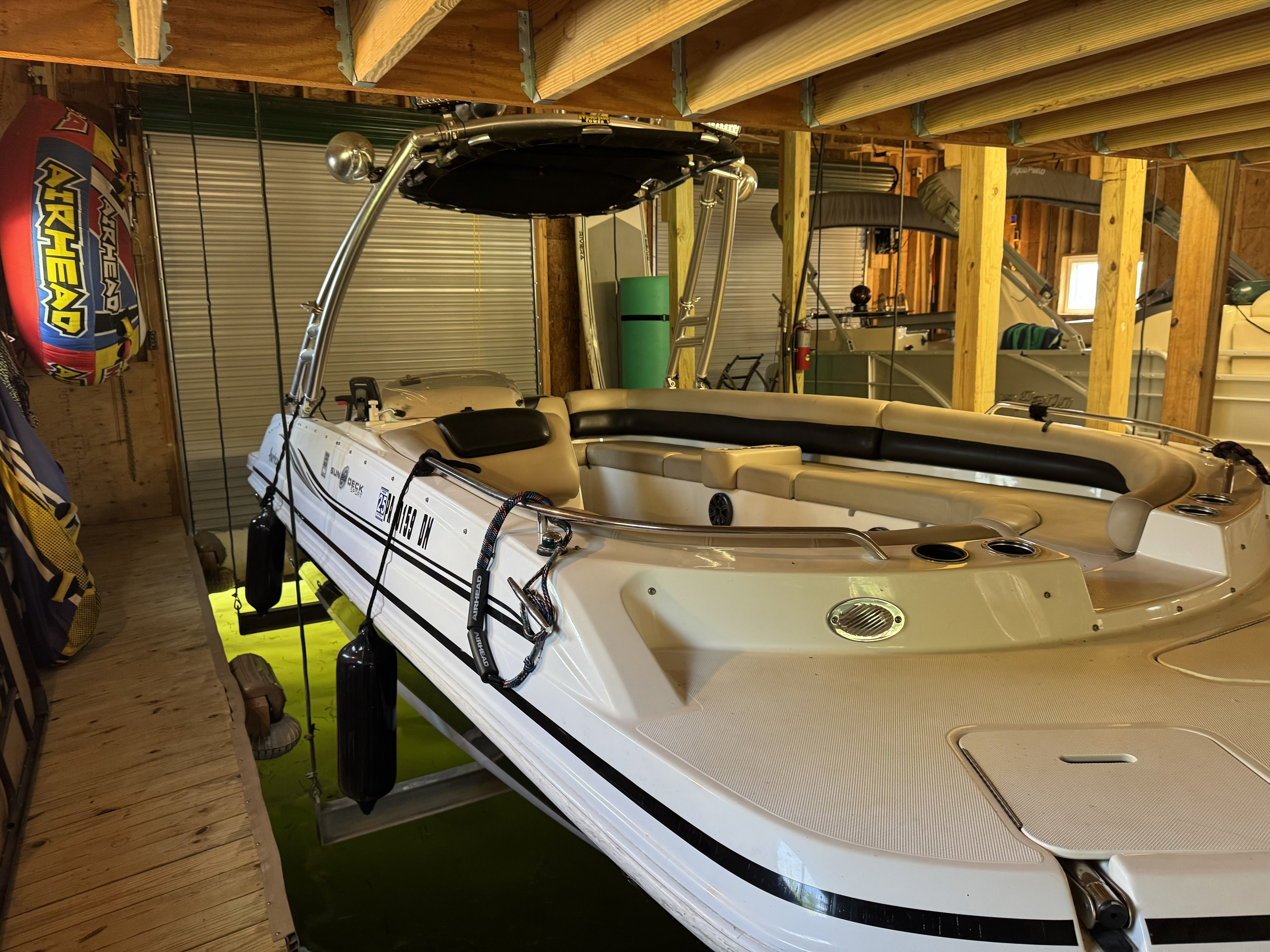 A 2014 Hurricane SS201 I/O boat stored in a covered boathouse.