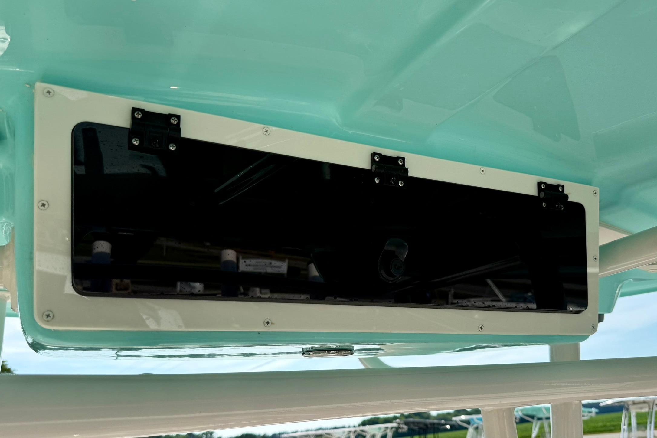 2026 Carolina Skiff 24 Ultra Elite boat storage compartment with sleek black panel.