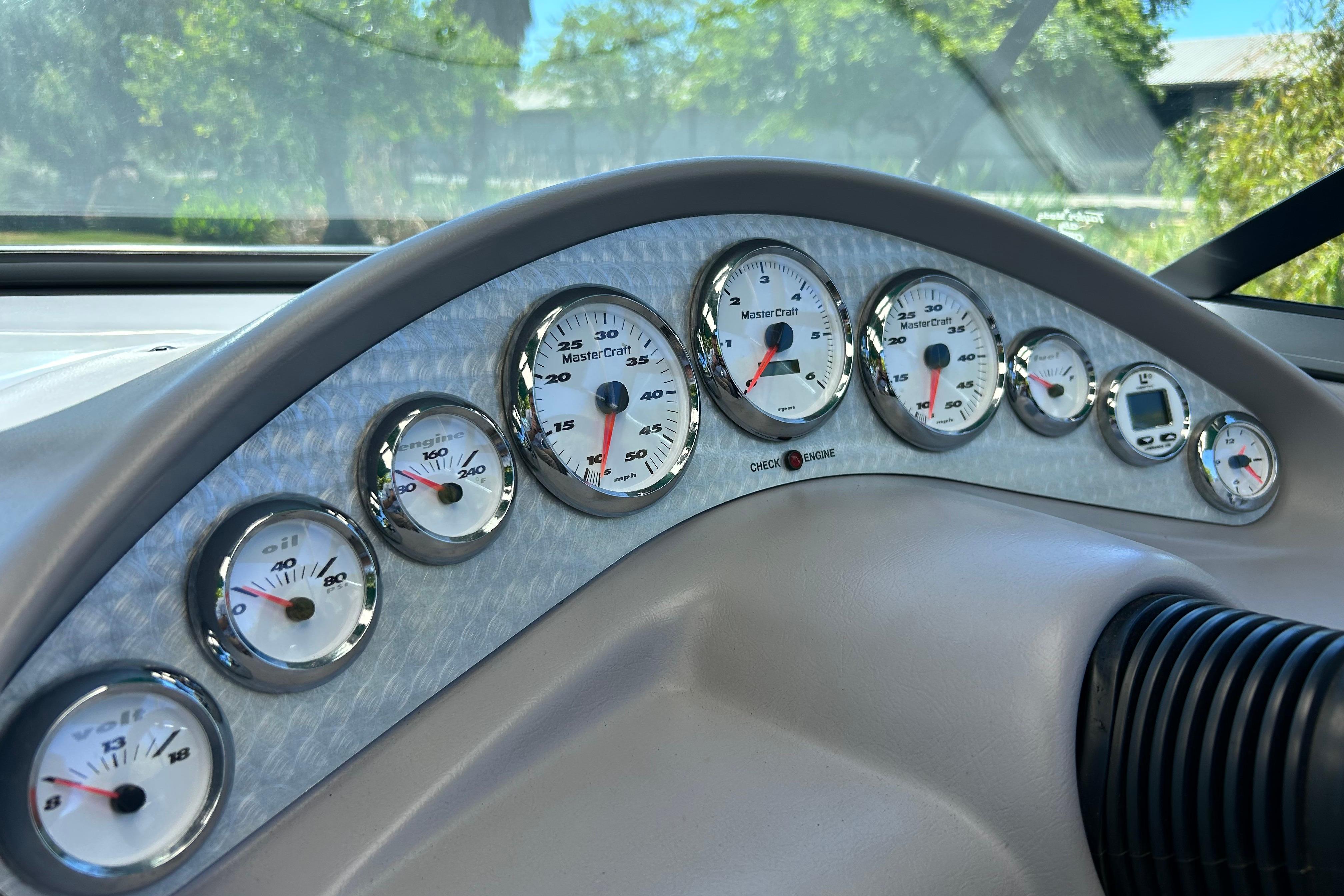 Dashboard of a 2002 MasterCraft ProStar 197 boat with multiple gauges and dials.