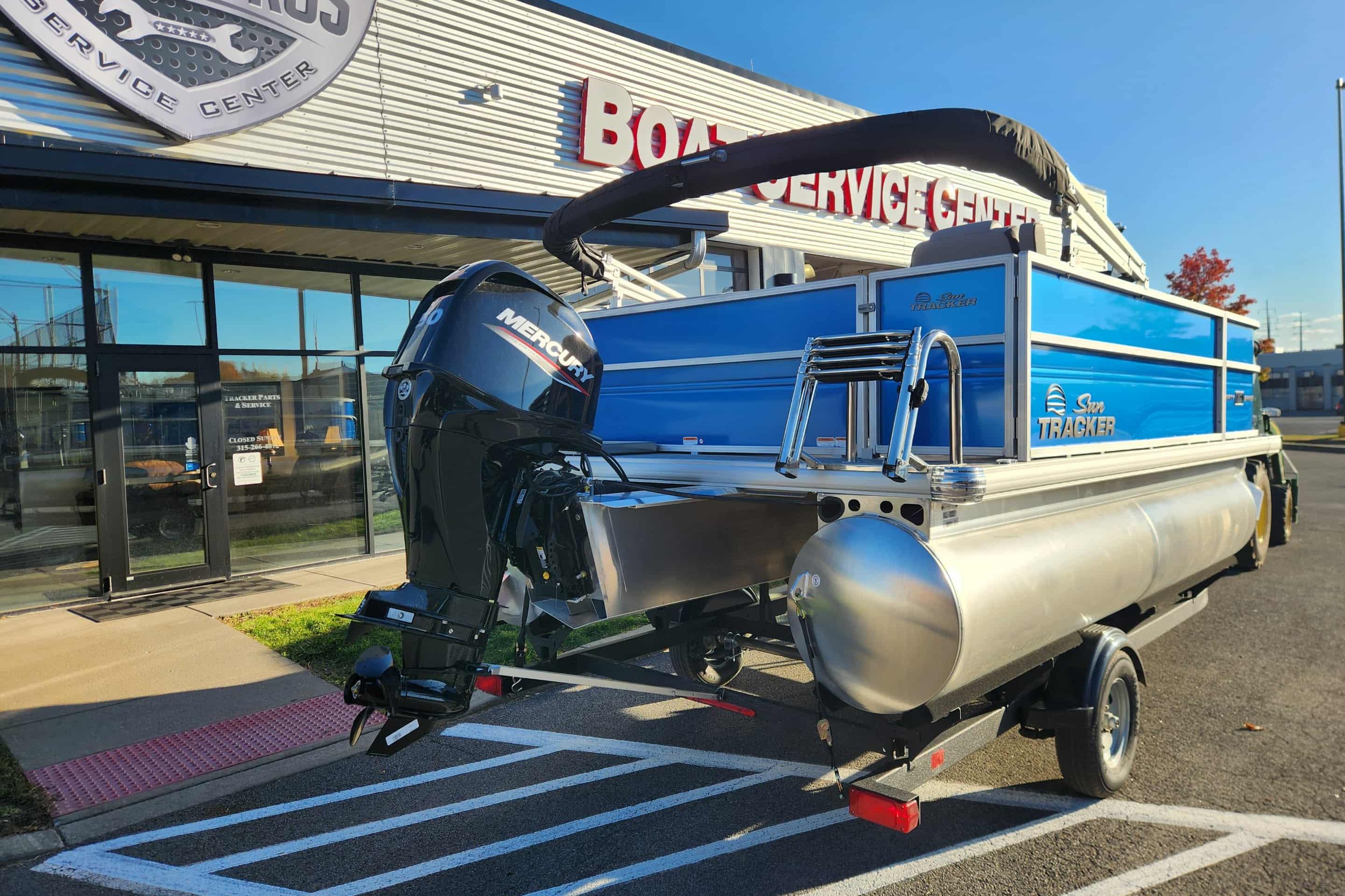 2026 Sun Tracker Party Barge 16 DLX pontoon boat outside service center.