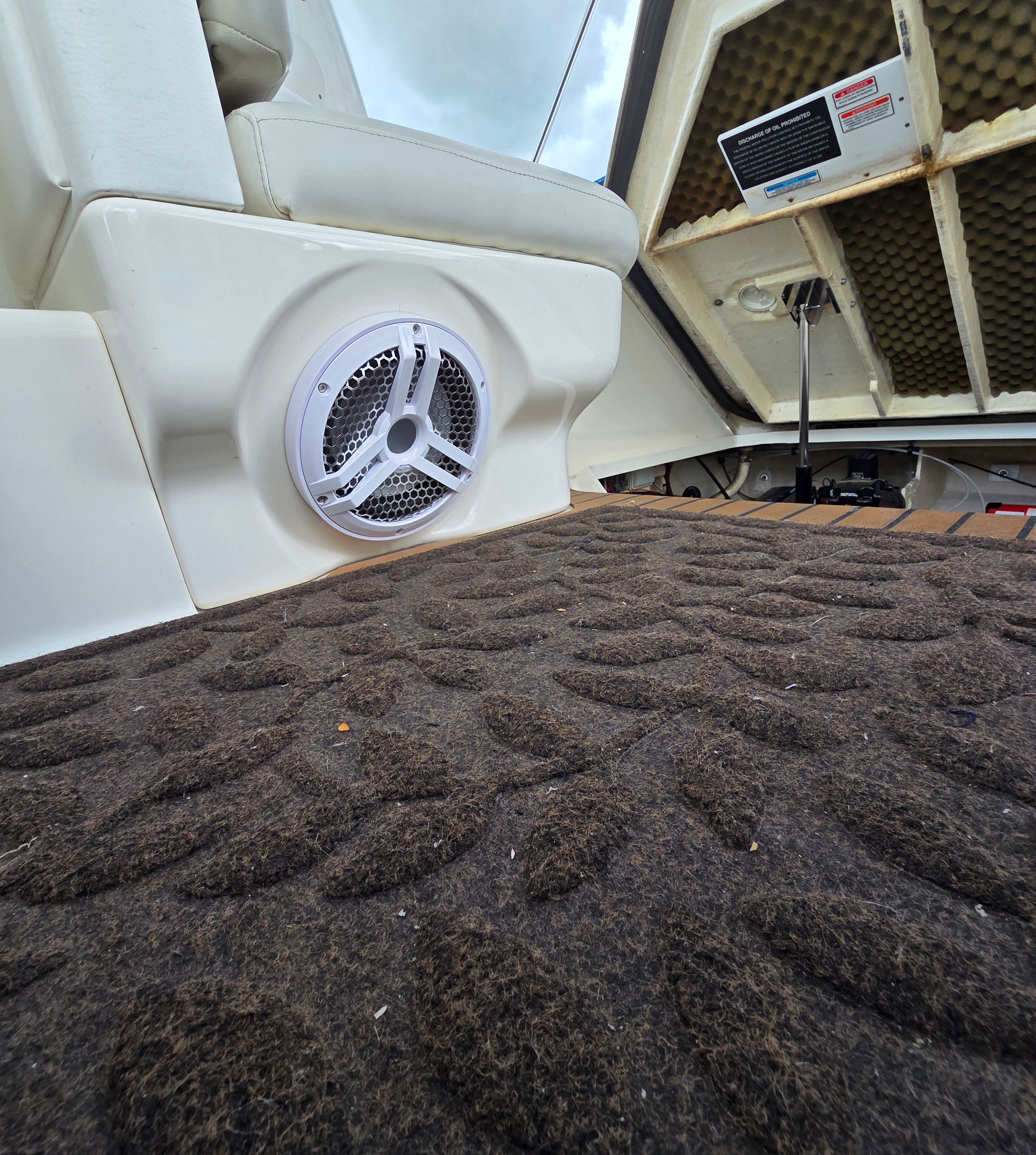 Close-up of a 2005 Sea Ray Sundancer 260 interior with speaker and carpet.
