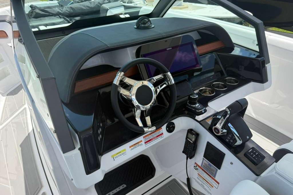 2026 Monterey Elite 30 OB boat dashboard with modern steering wheel and control panel.