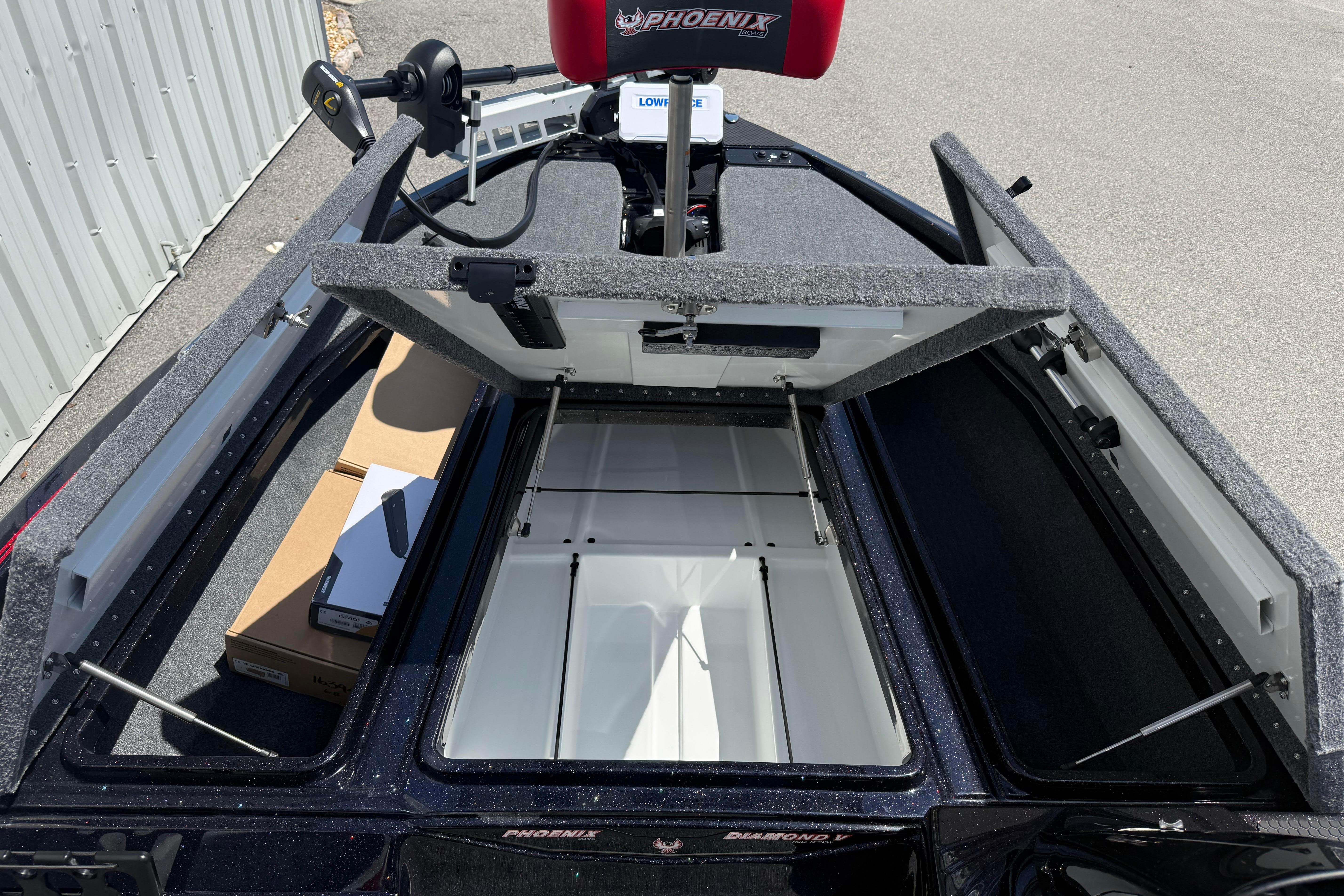 Open storage compartments on a 2027 Phoenix 919 ZXL boat, showcasing interior space.